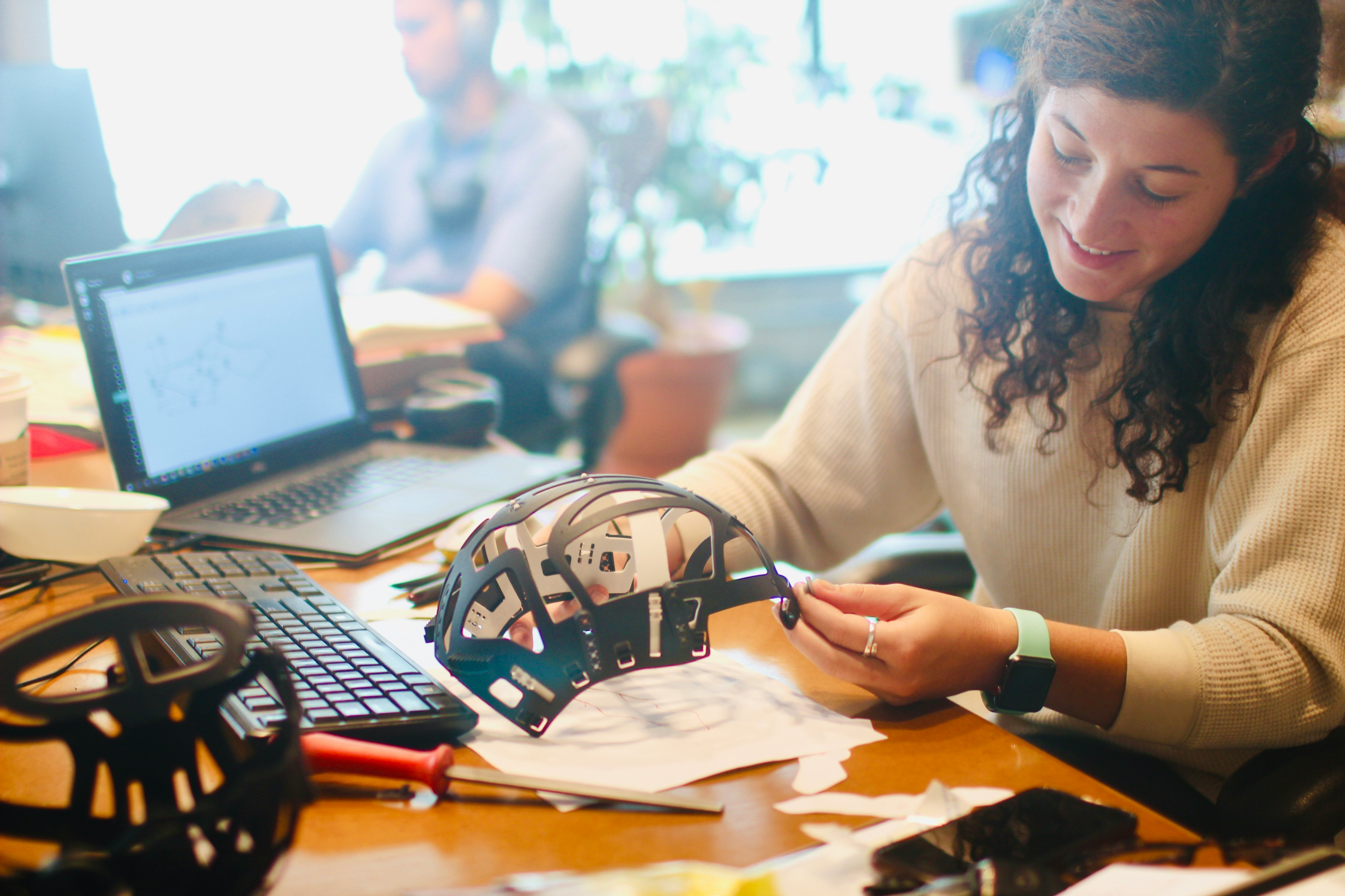 Woman testing product on desk.