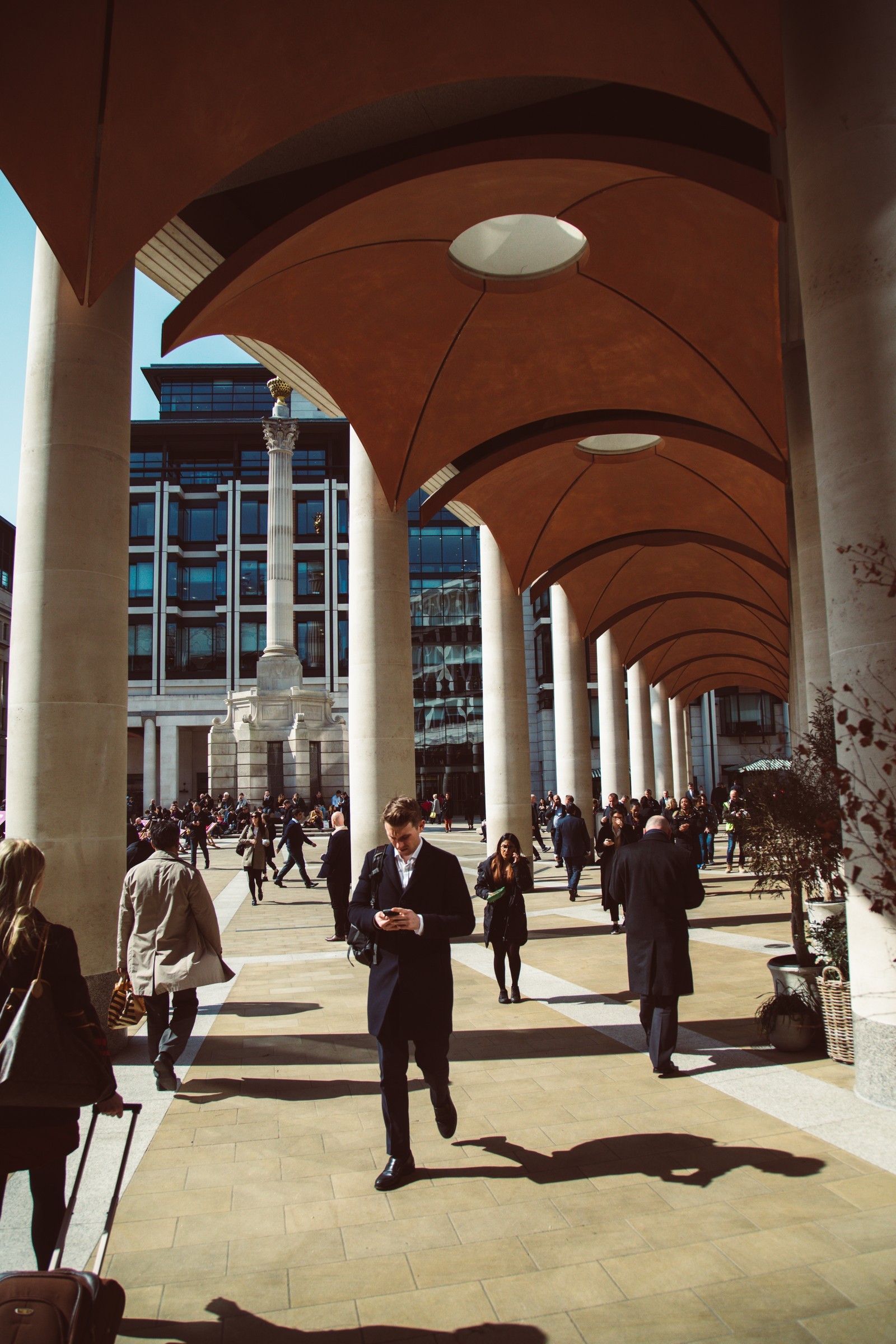 TRAVEL — Light and shadow beneath a city arcade.