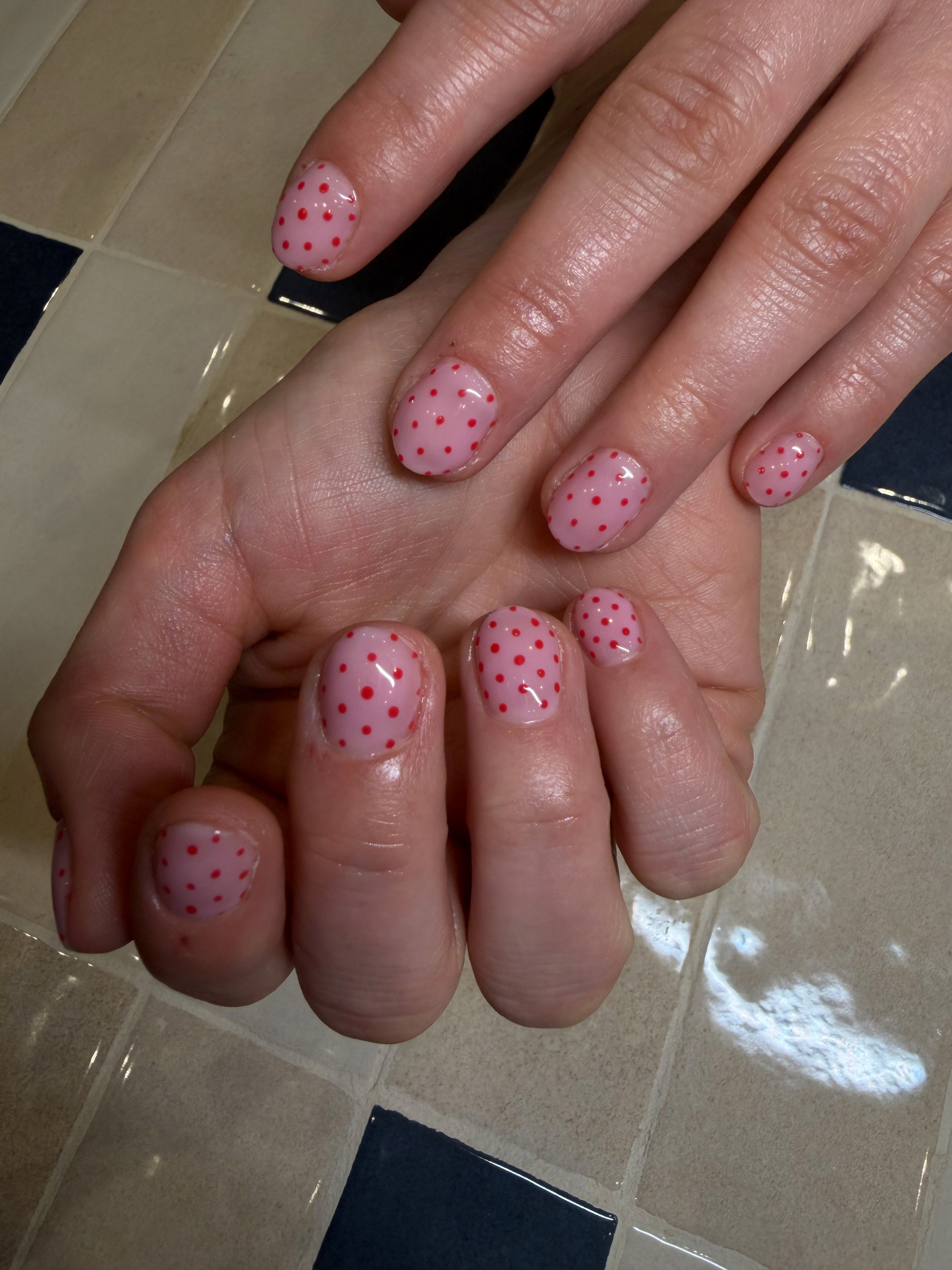 Short pink jelly gel nails with red polka dots, squoval shape, Brava Nails Berlin