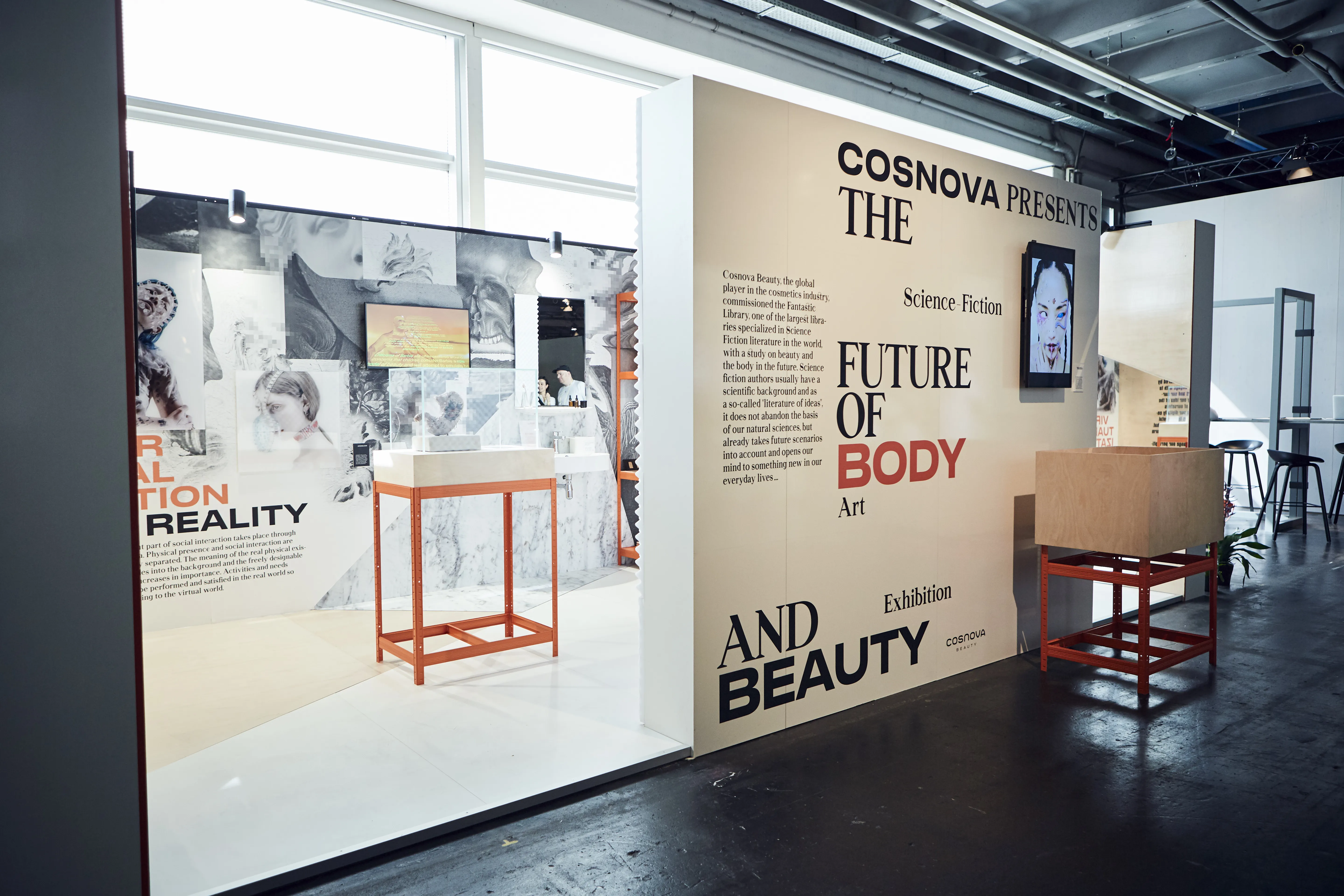 Overall view of the Cosnova Presents The Future of Body and Beauty exhibition booth with typographic walls and orange display racks.