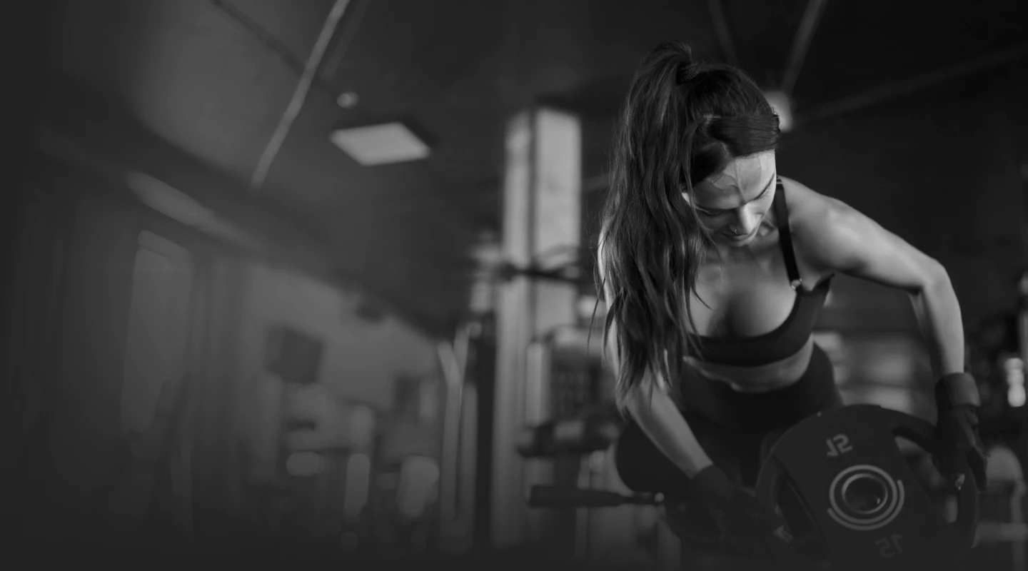 Woman lifting dumbbells at the gym