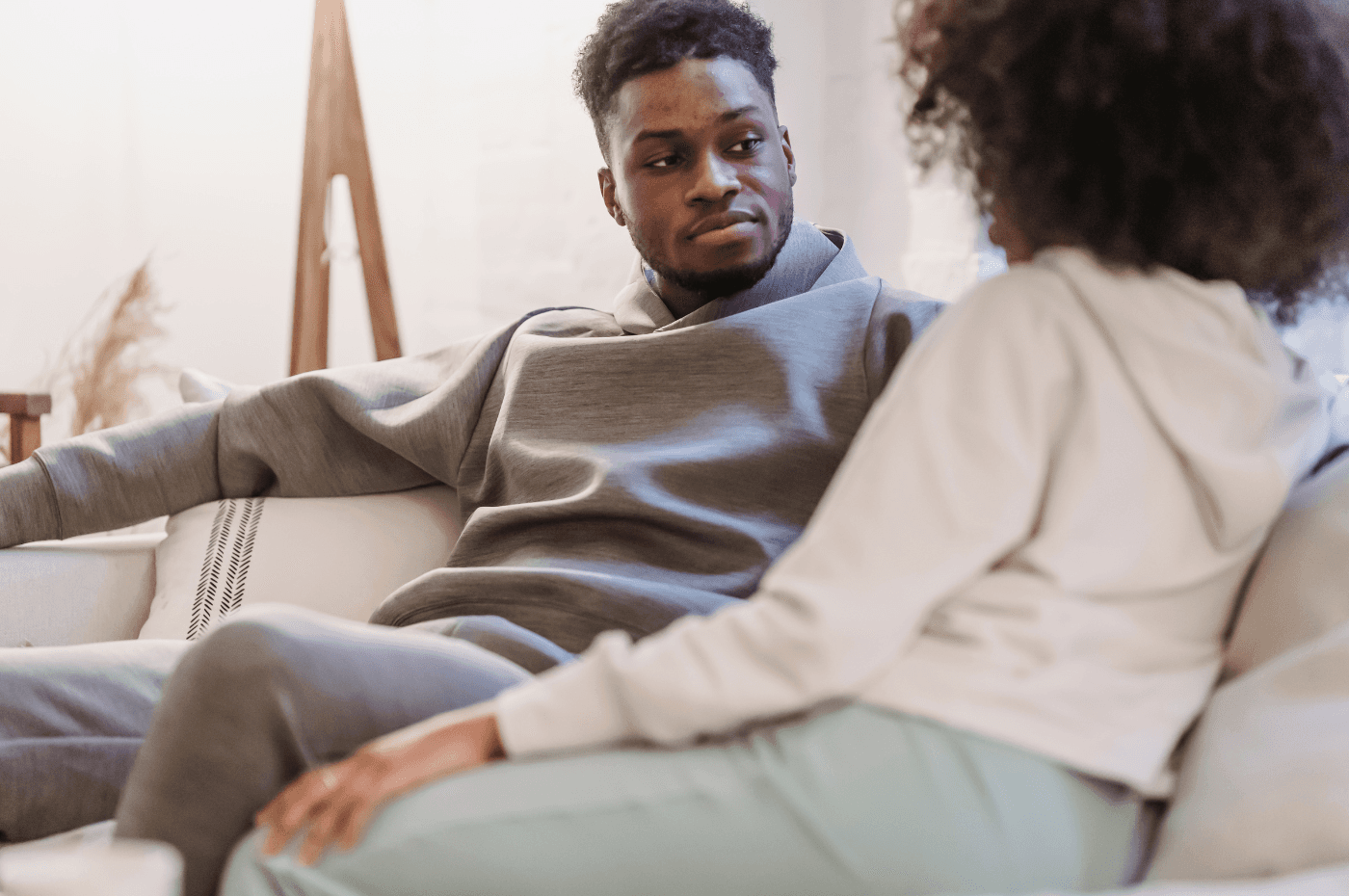 Black couple in casual clothes resting and talking