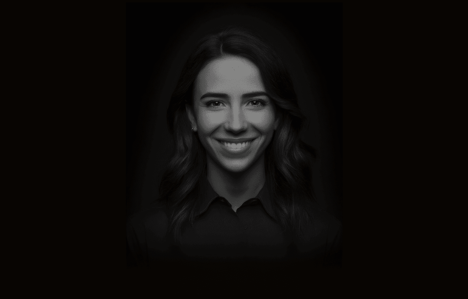 Portrait of a woman smiling against a dark background