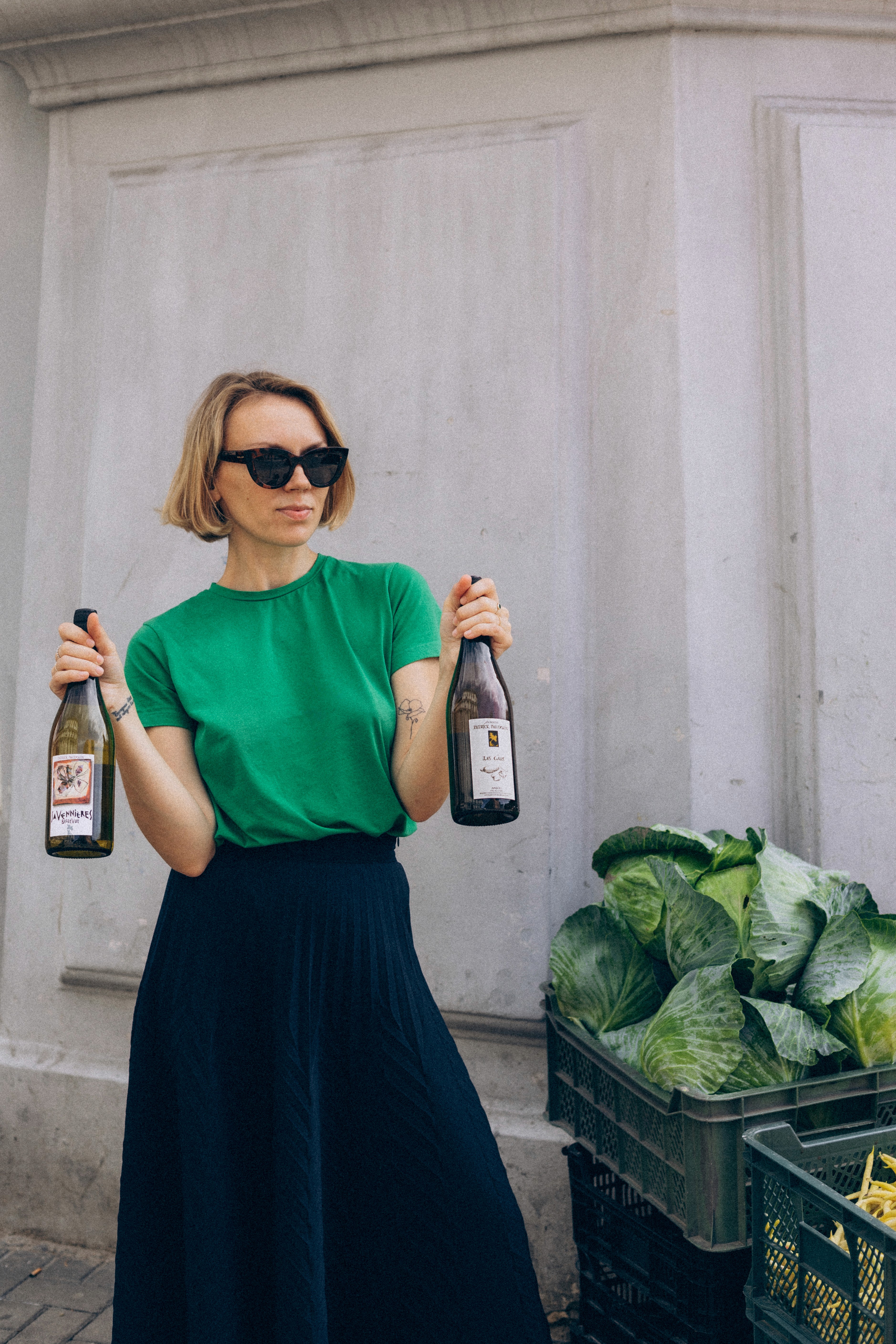 A person sits by a window, gazing thoughtfully outside, with soft lighting and city scenery in the background.