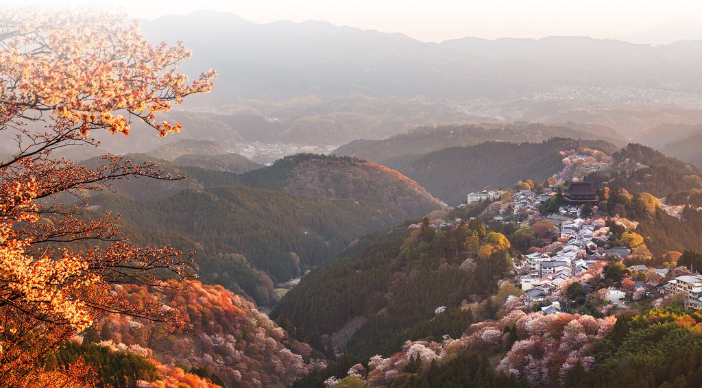 Beautiful mountain range in Japan shot from top of mountain overlooking valleys and town below, highlighting the conenction and data coverage of our eSIM