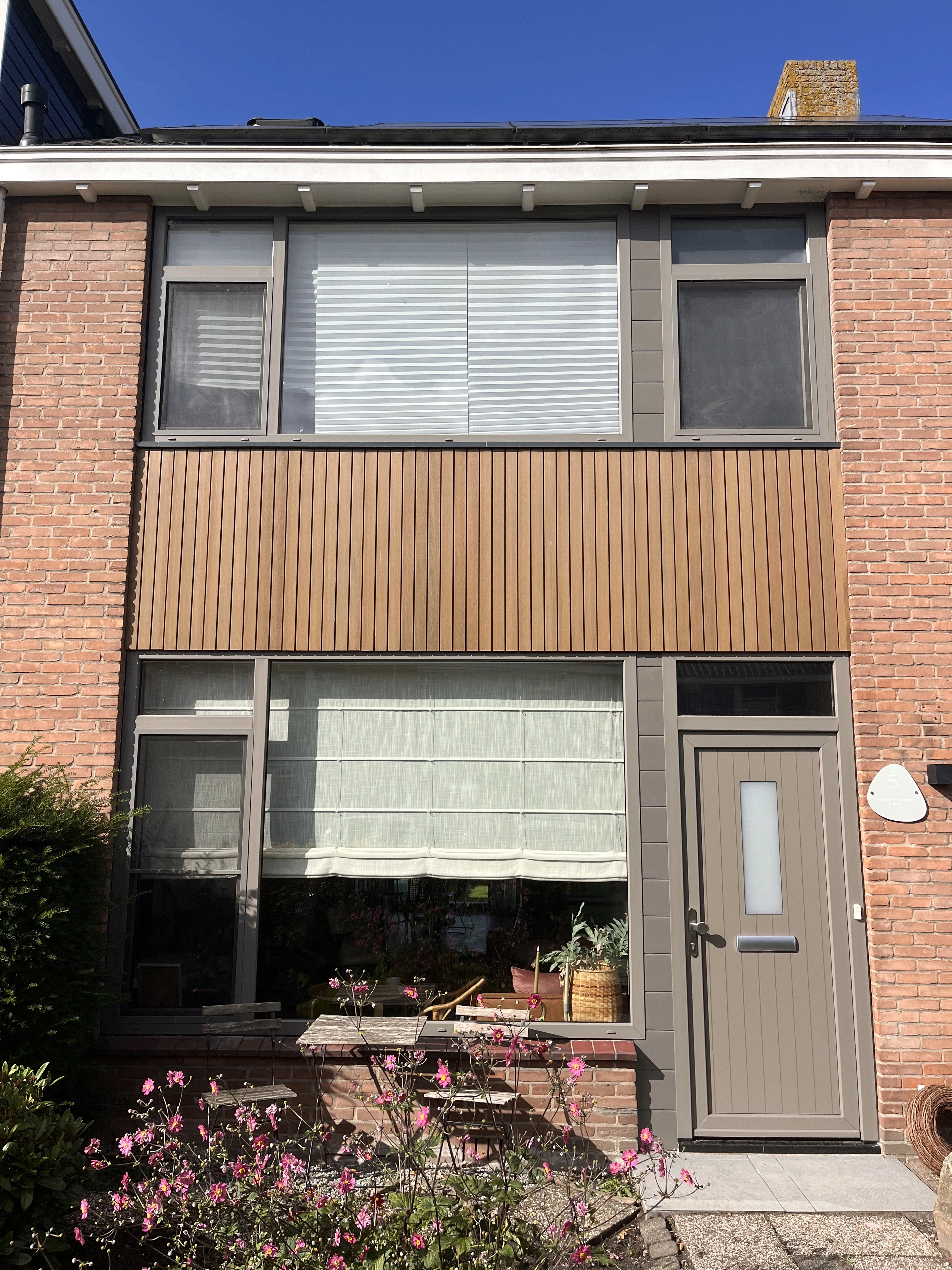 utility man standing in scissor platform cleaning glass window