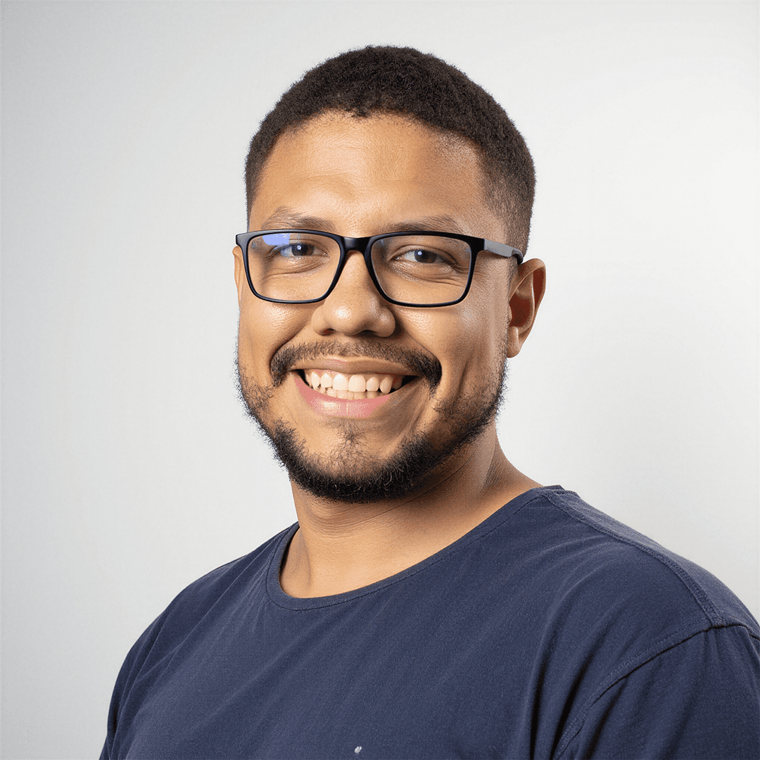 A thoughtful young person with dark hair gazes to the side, captured in soft black and white lighting.