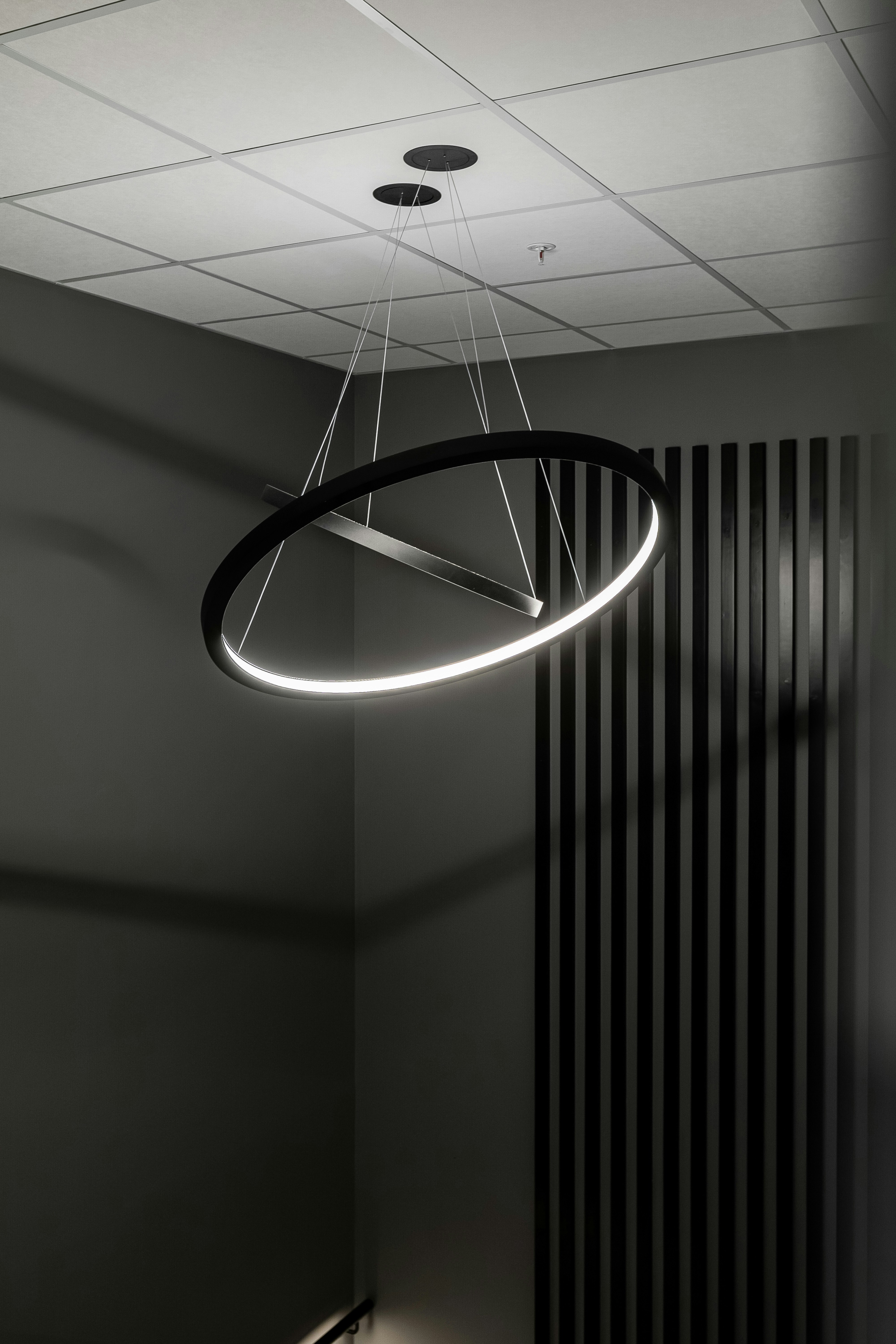 A circular light fixture hanging from a ceiling
