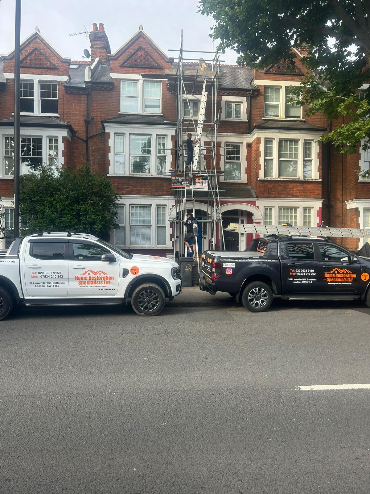 Flat roof installation in progress with black felt being laid over wooden decking on a UK property.