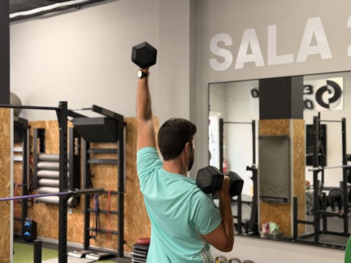 woman standing surrounded by exercise equipment