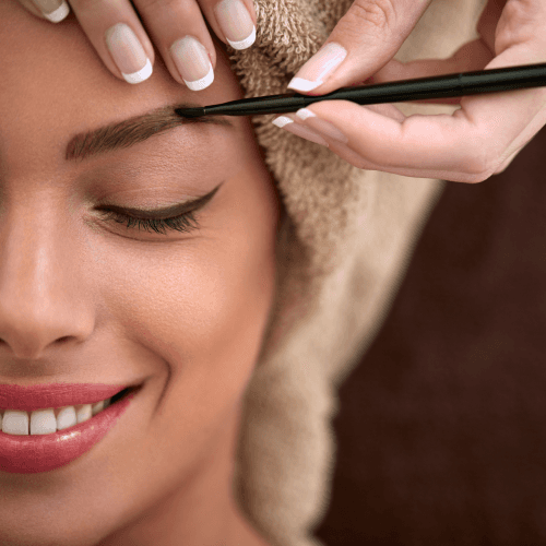 A woman getting her brows done at a spa