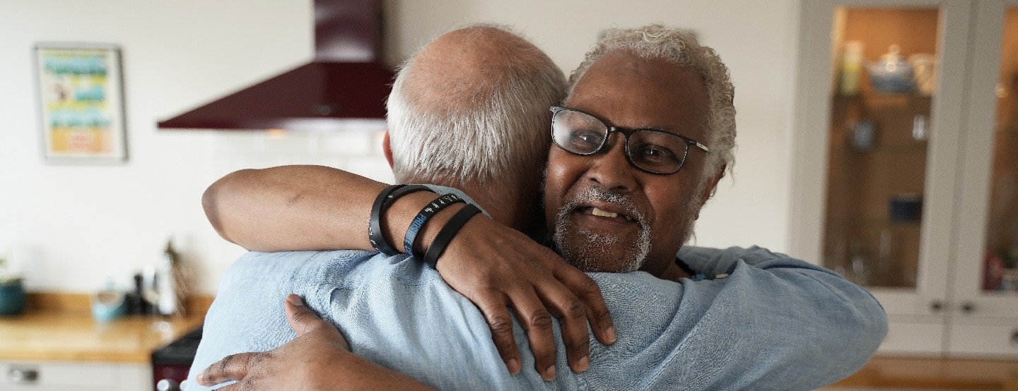 Two elderly men hugging each other. Friendship. Support