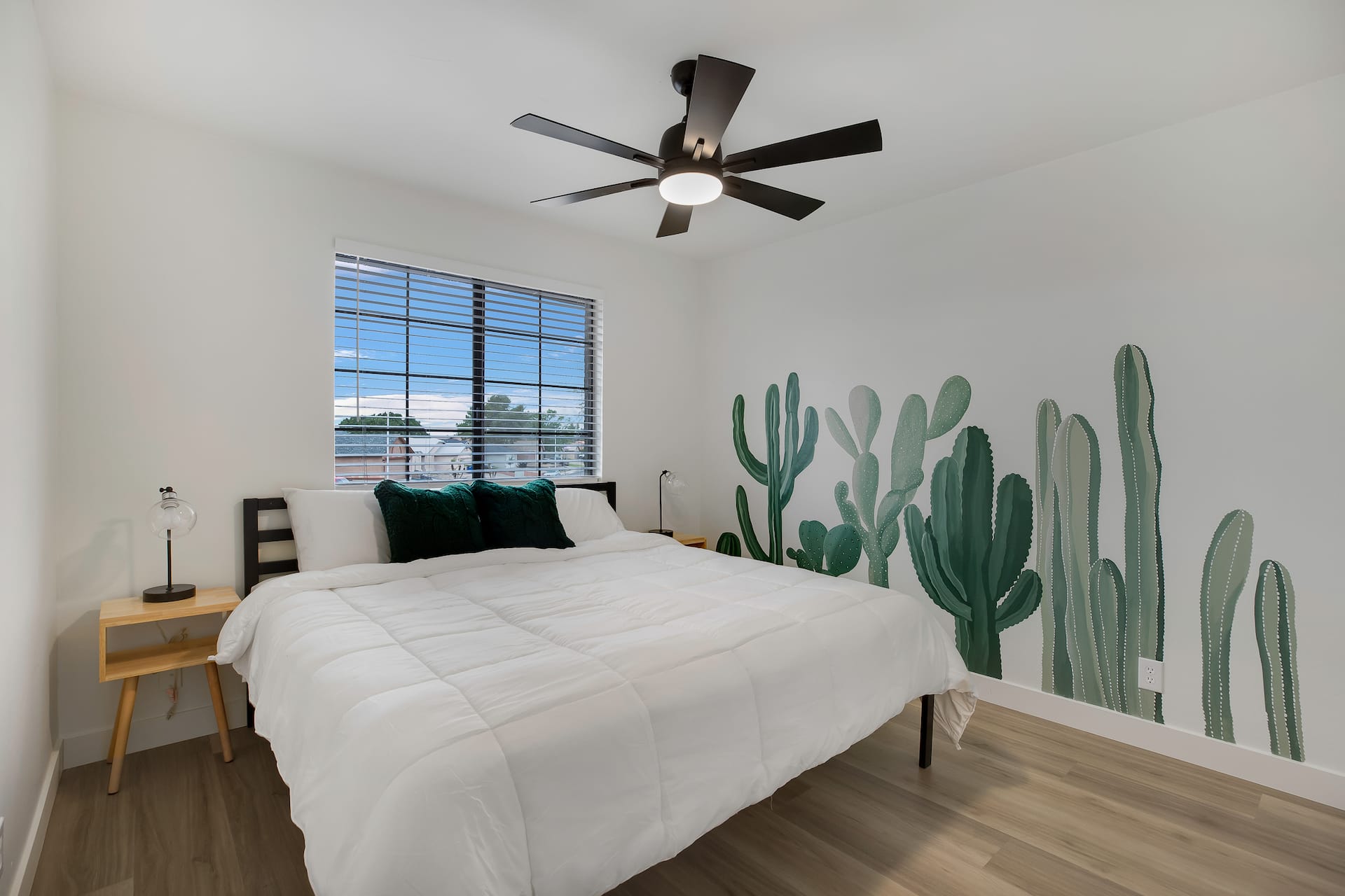 Bedroom with a king bed and cactus mural