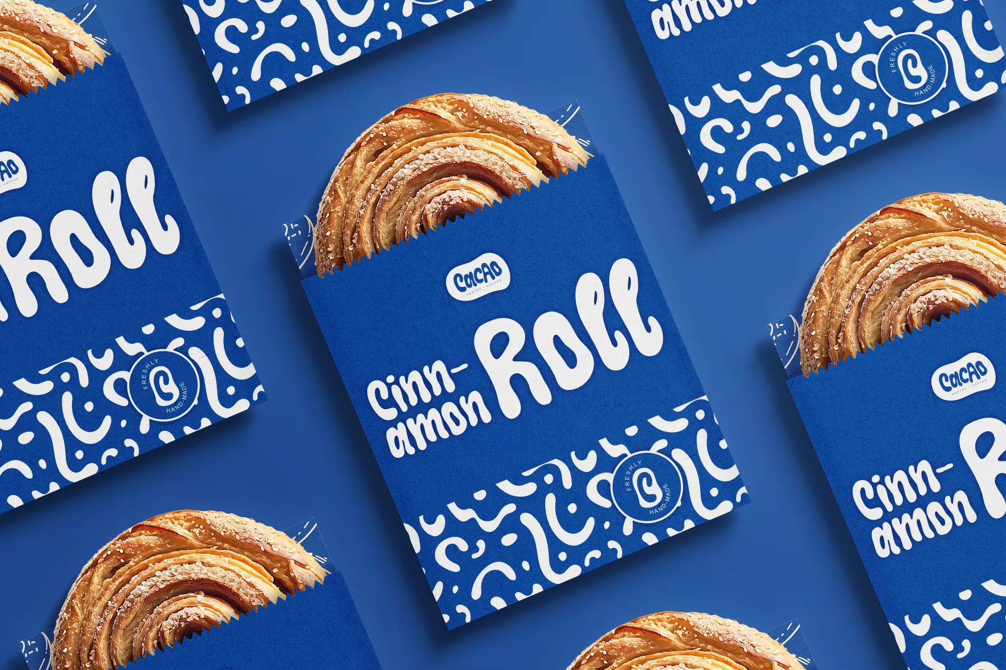 A neatly arranged pattern of pastry bags filled with cinnamon rolls, featuring the product name, Cacao logo, and brand pattern by Studio Liminal.
