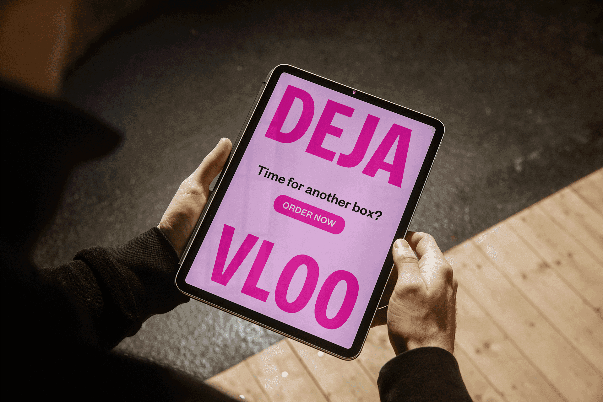Hands holding a tablet with VLOO website order page "DEJA VLOO" Time for another box?