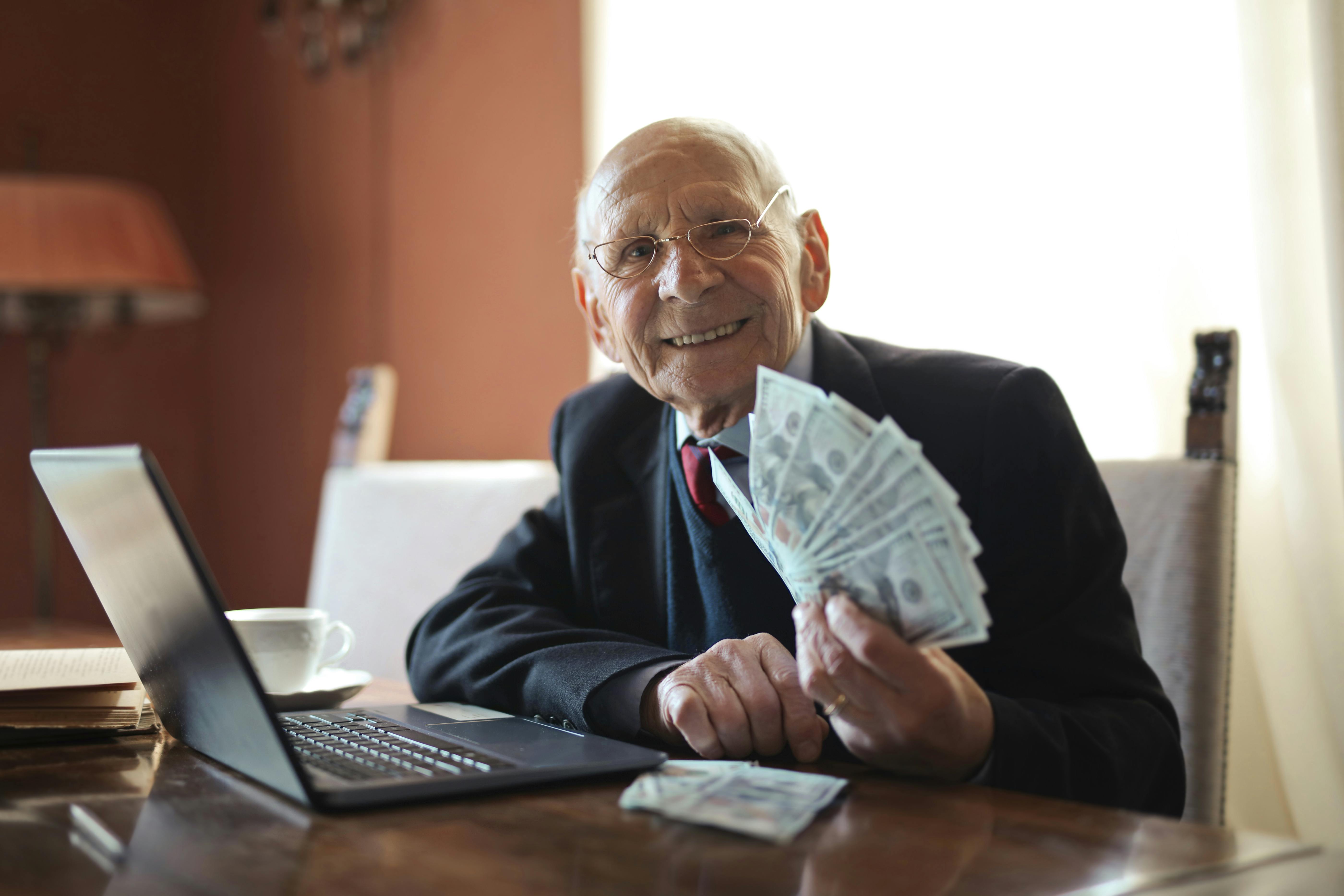 man holding a stack of cash