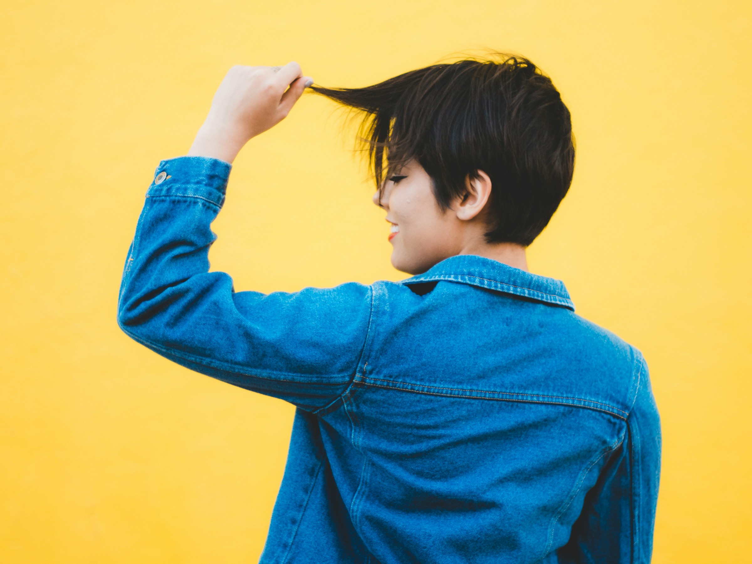 woman showing off her cool hair - Colors That Go With Dark Blue