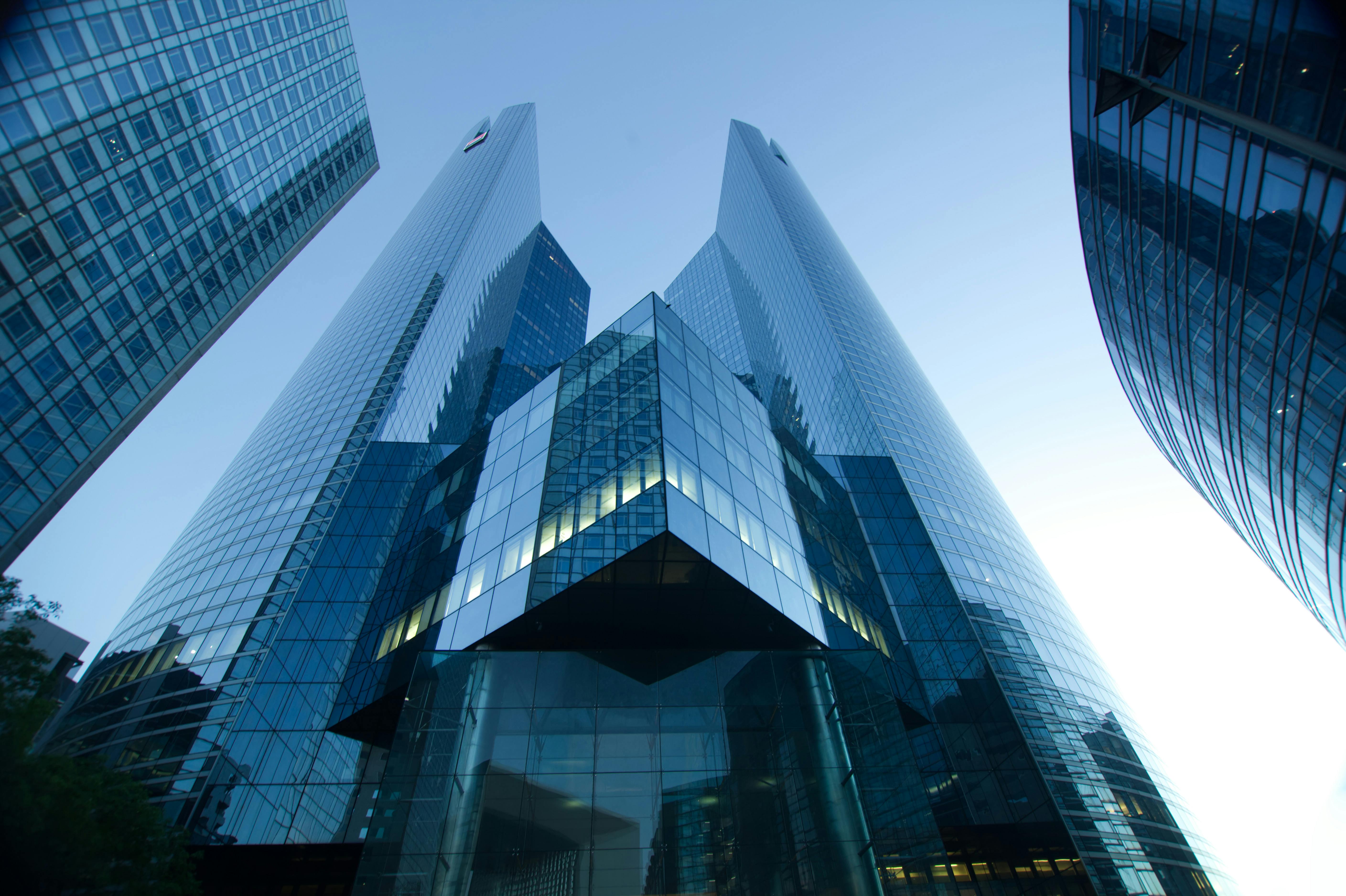 low-angle-view-of-modern-glass-skyscrapers-reflecting-a-clear-blue-sky.-perfect- - césar-guillotel (pexels)