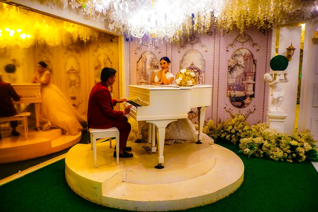 Couple at the white piano in golden light at Celestia Hall, Stalla Suites Events Place