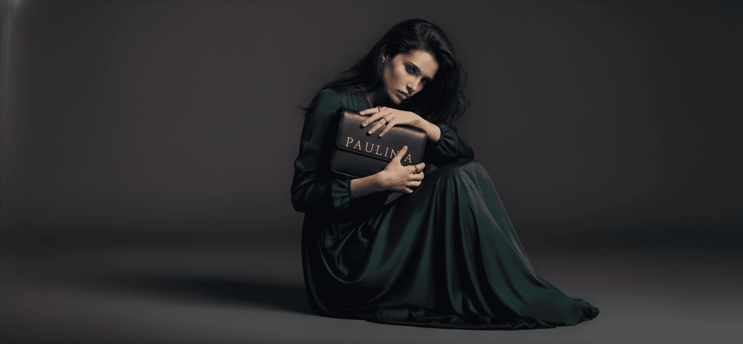 model clutching a purse in a seated position