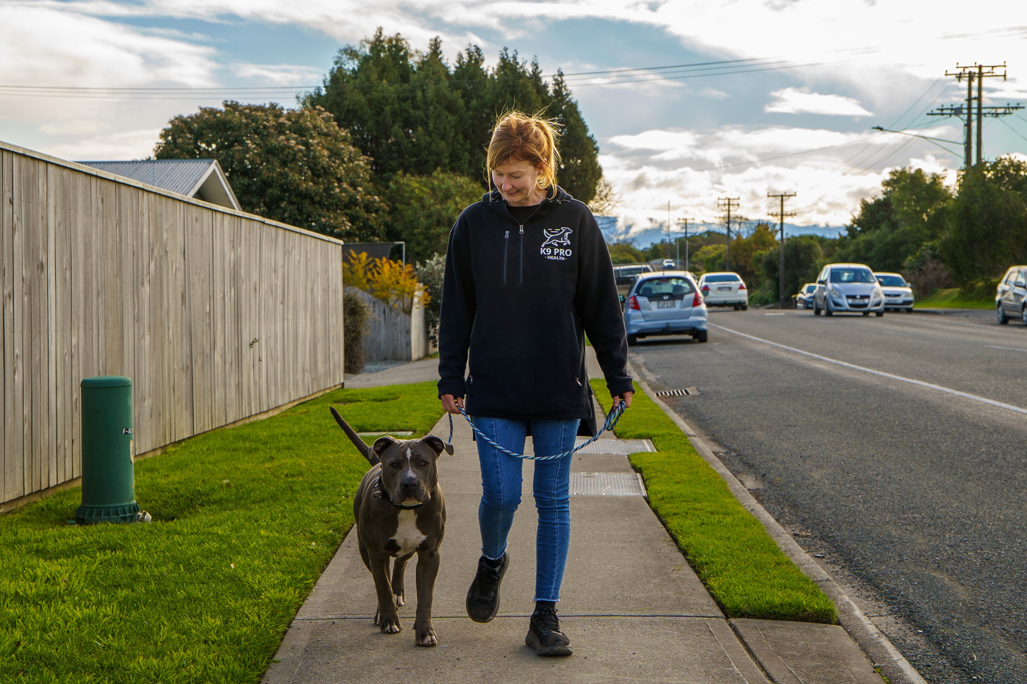 Ally walking a dog on a loose leash in Nelson