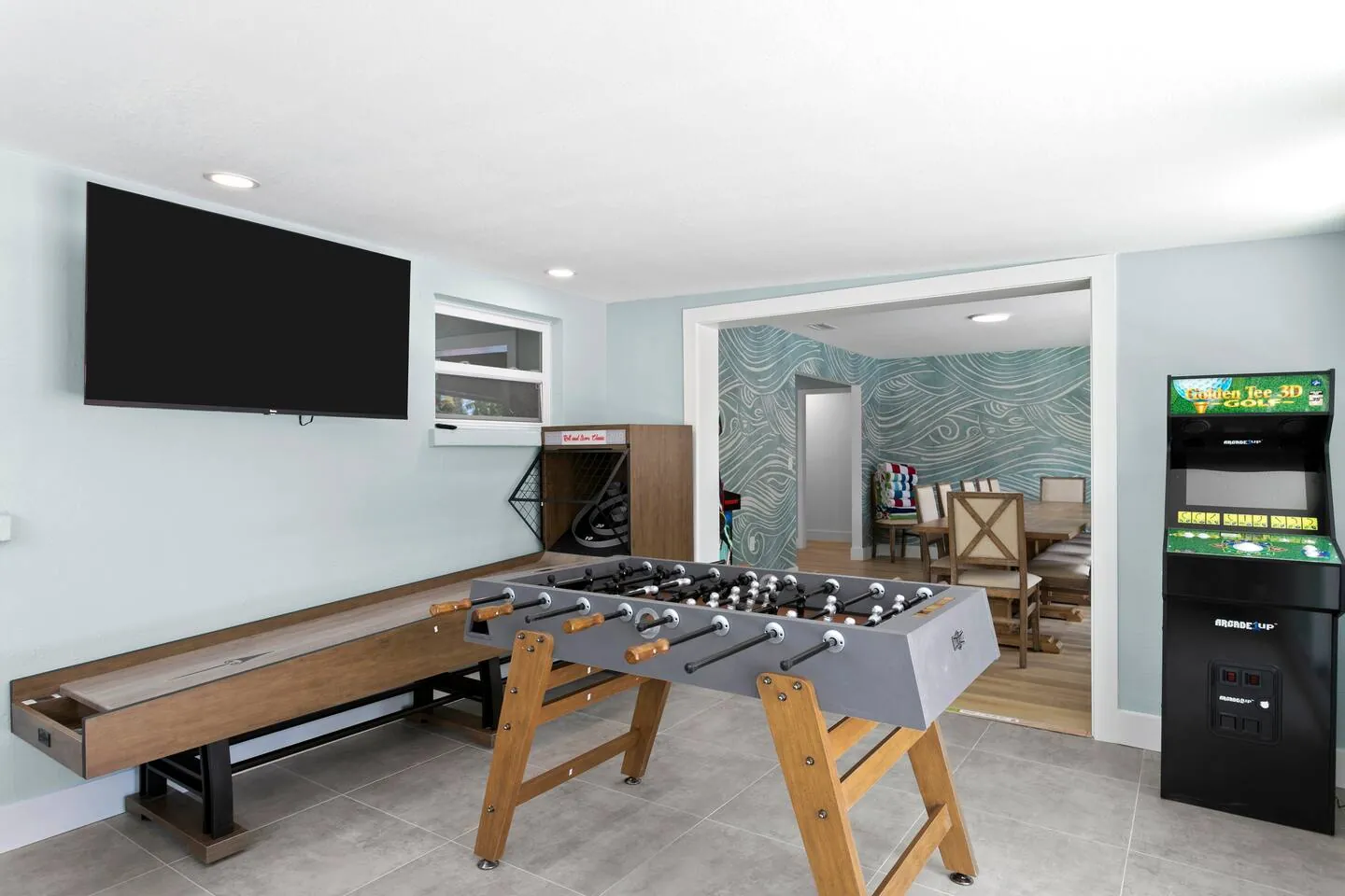 Game room with shuffleboard table, foosball and arcade at Salty House, Bradenton, Florida