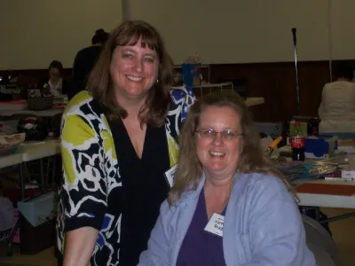 Two women smiling at their crop table