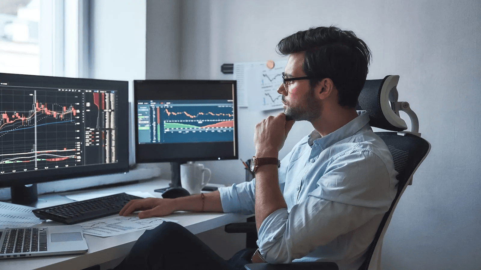 Man analyzing complex financial data displays - What Does Onchain Mean in Crypto