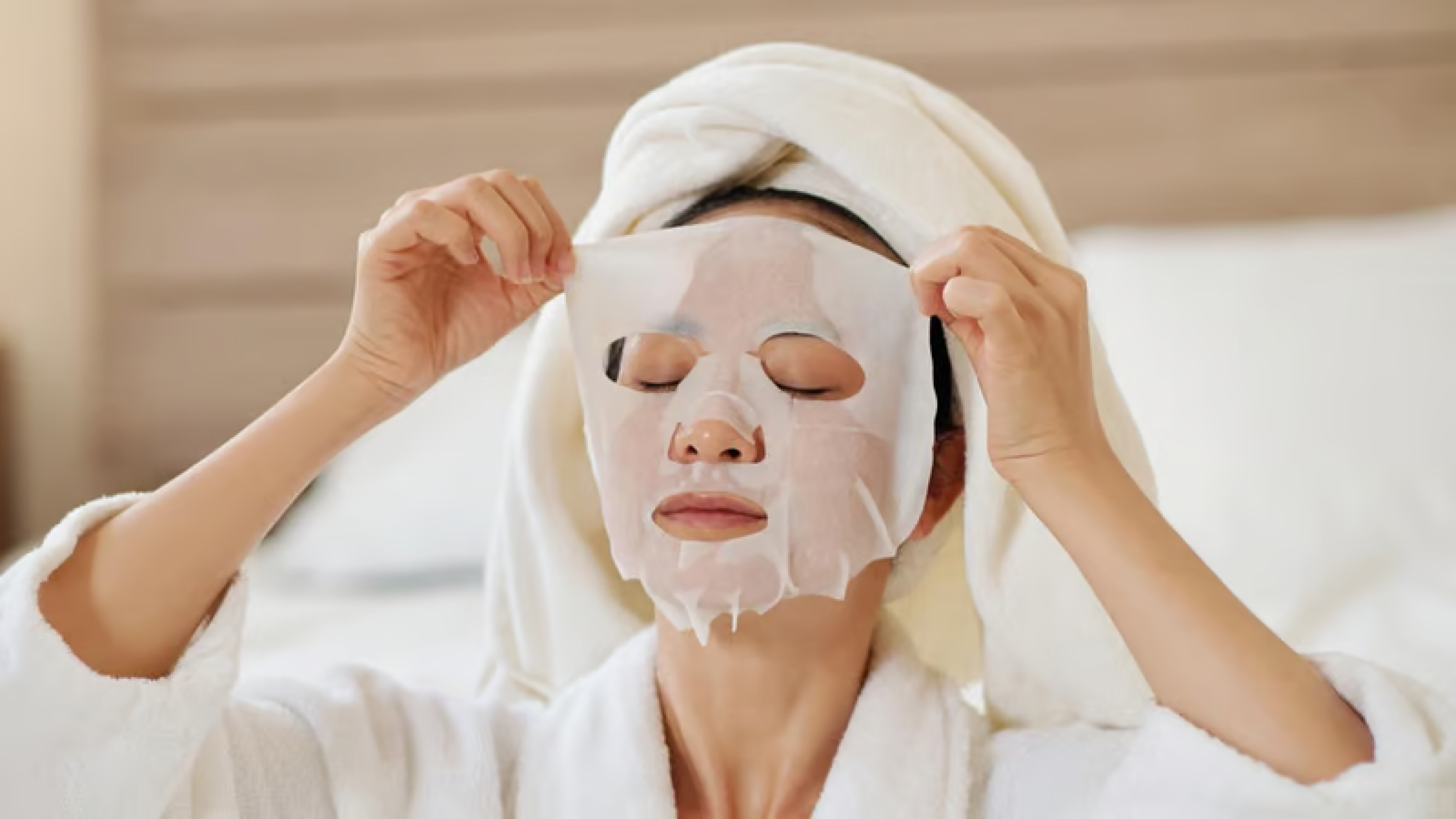 Woman applying a sheet mask for hydrated and glowing skin