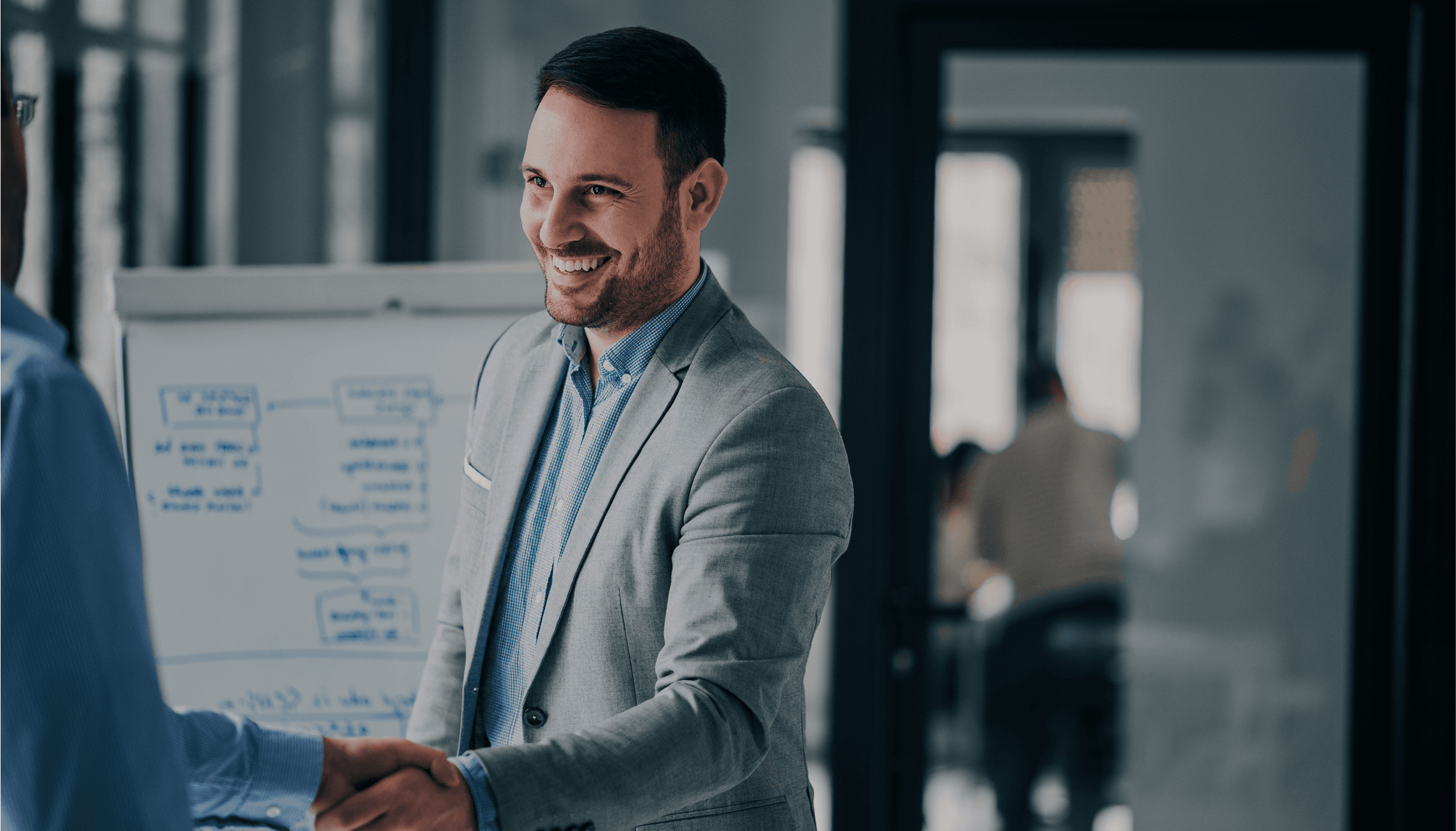 man in blue long sleeve shirt holding woman in gray sweater