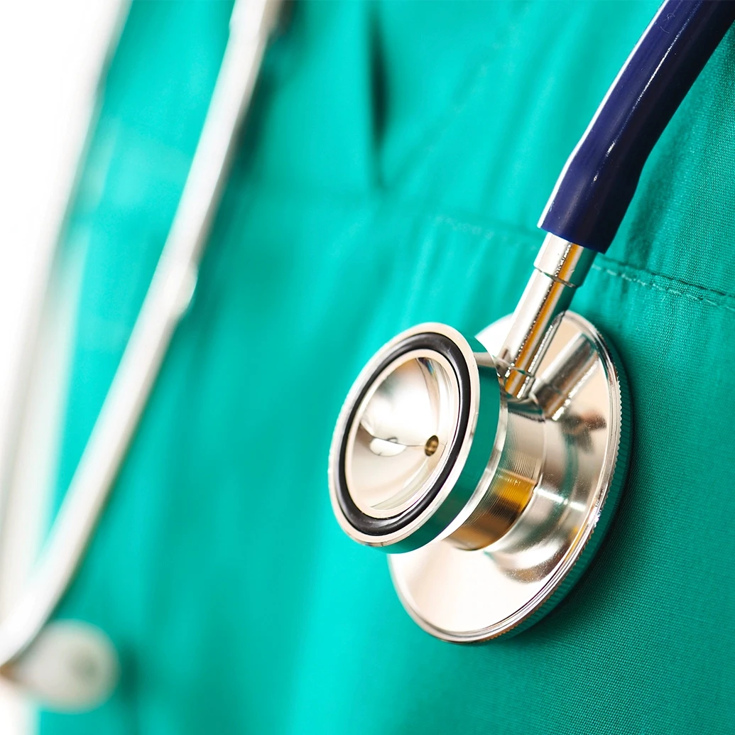 Close-up of a stethoscope around a doctor’s neck, representing medical care for spinal cord and paralysis injuries