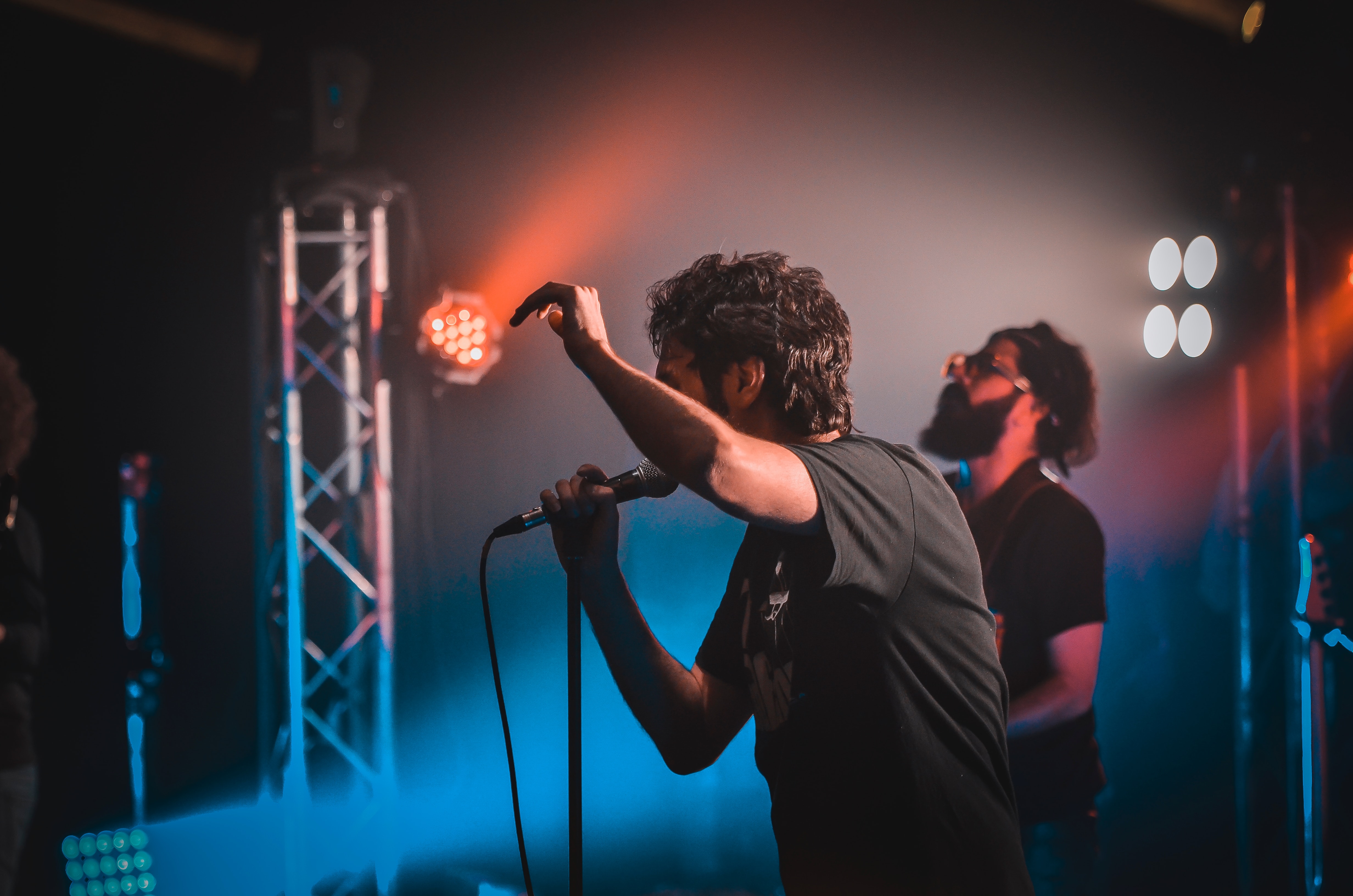man singing on stage - how to write love songs