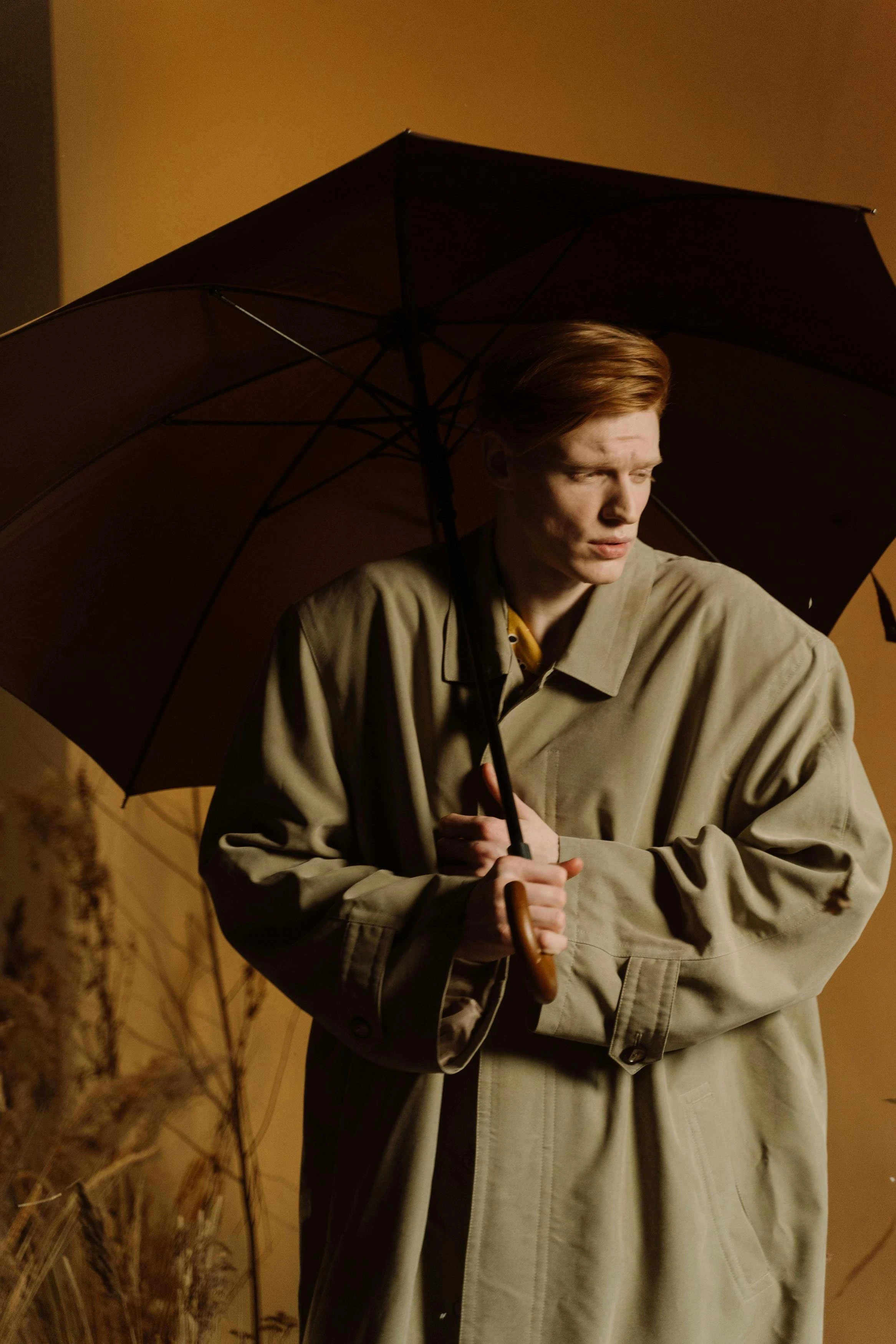 Ethan Harper is posing with umbrella