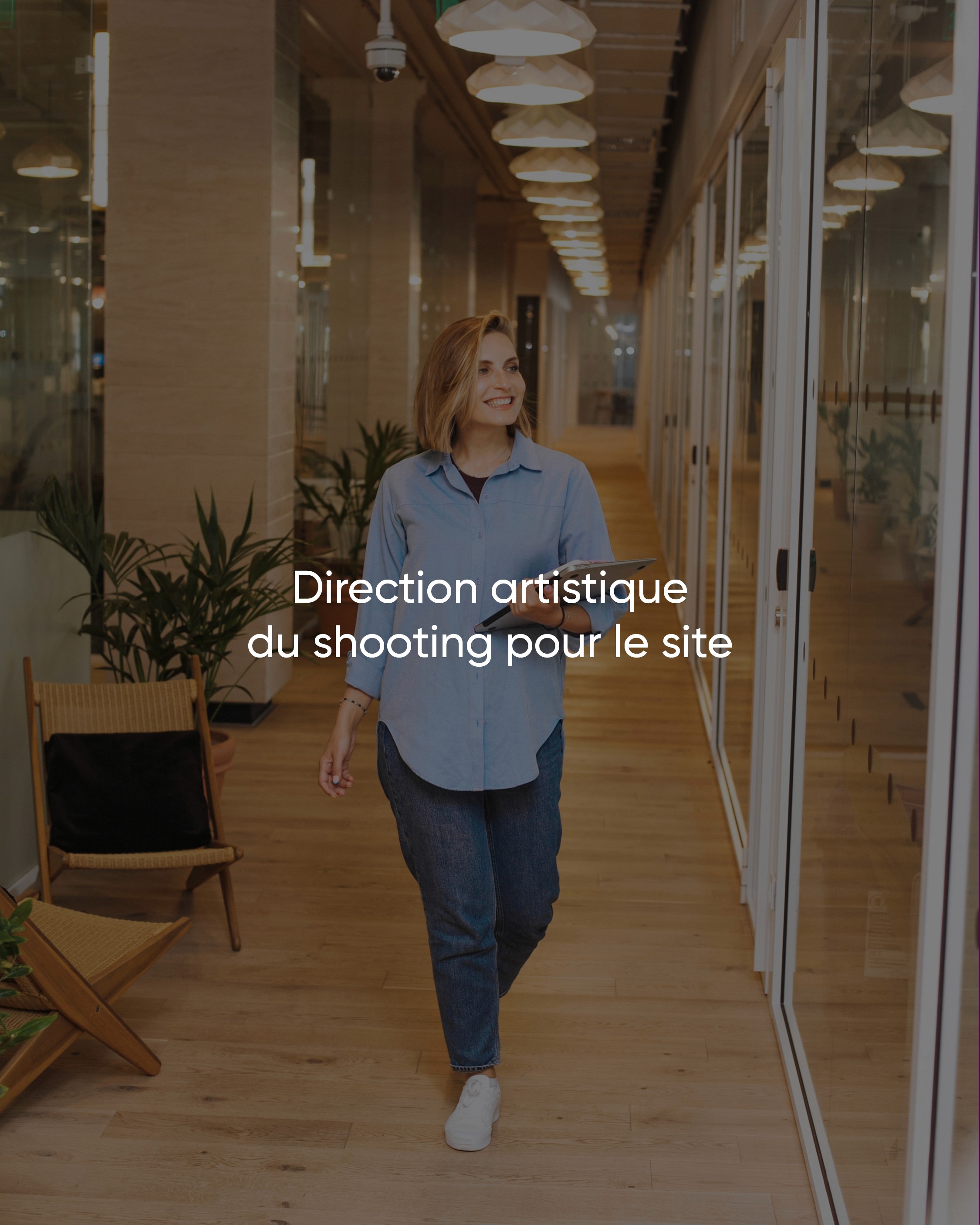 Modern home office setup with a monitor, ergonomic chair, keyboard, and indoor plants near a window with blinds.