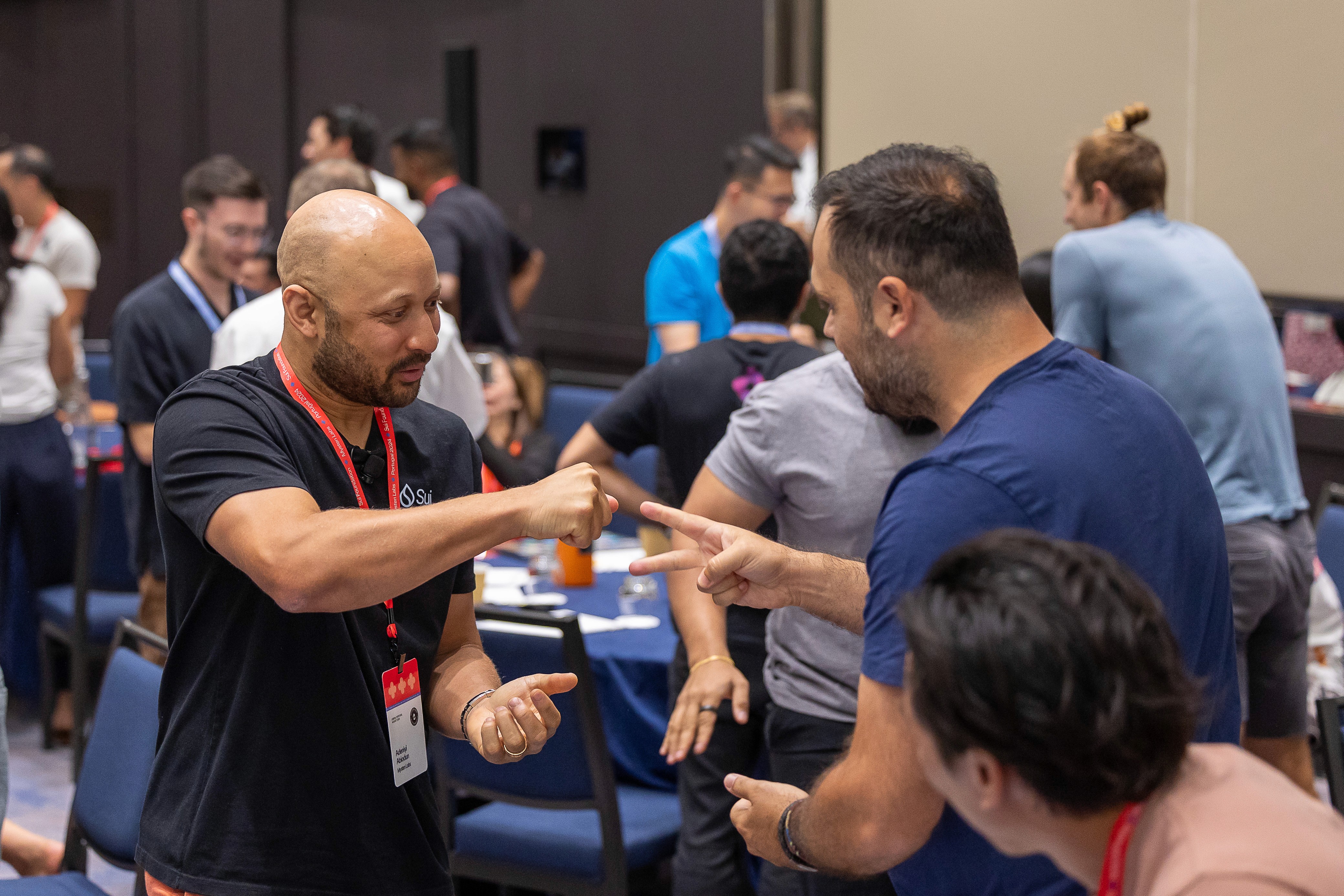 2 people playing rock paper scissors at a conference