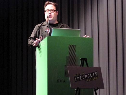 a man giving a speech from the greenstand
