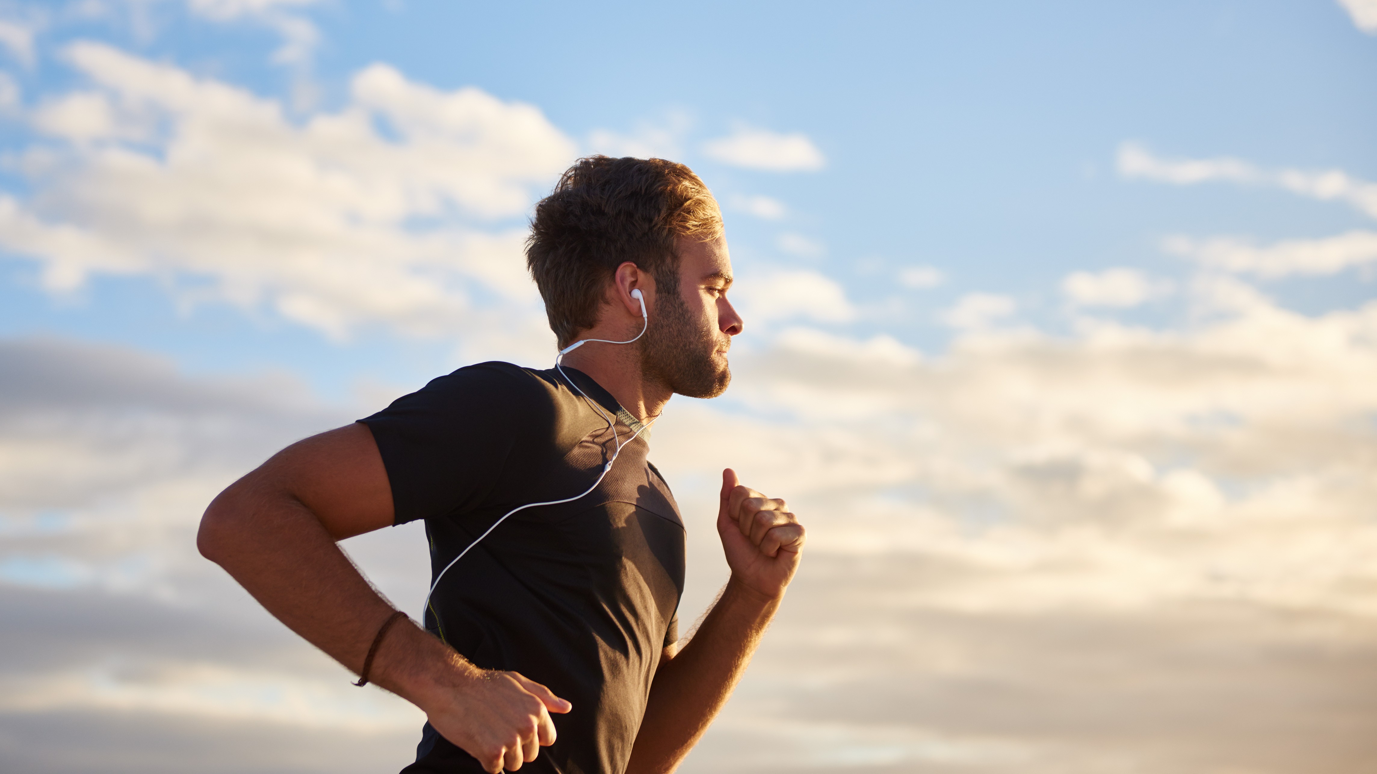 Man running outside listening to music