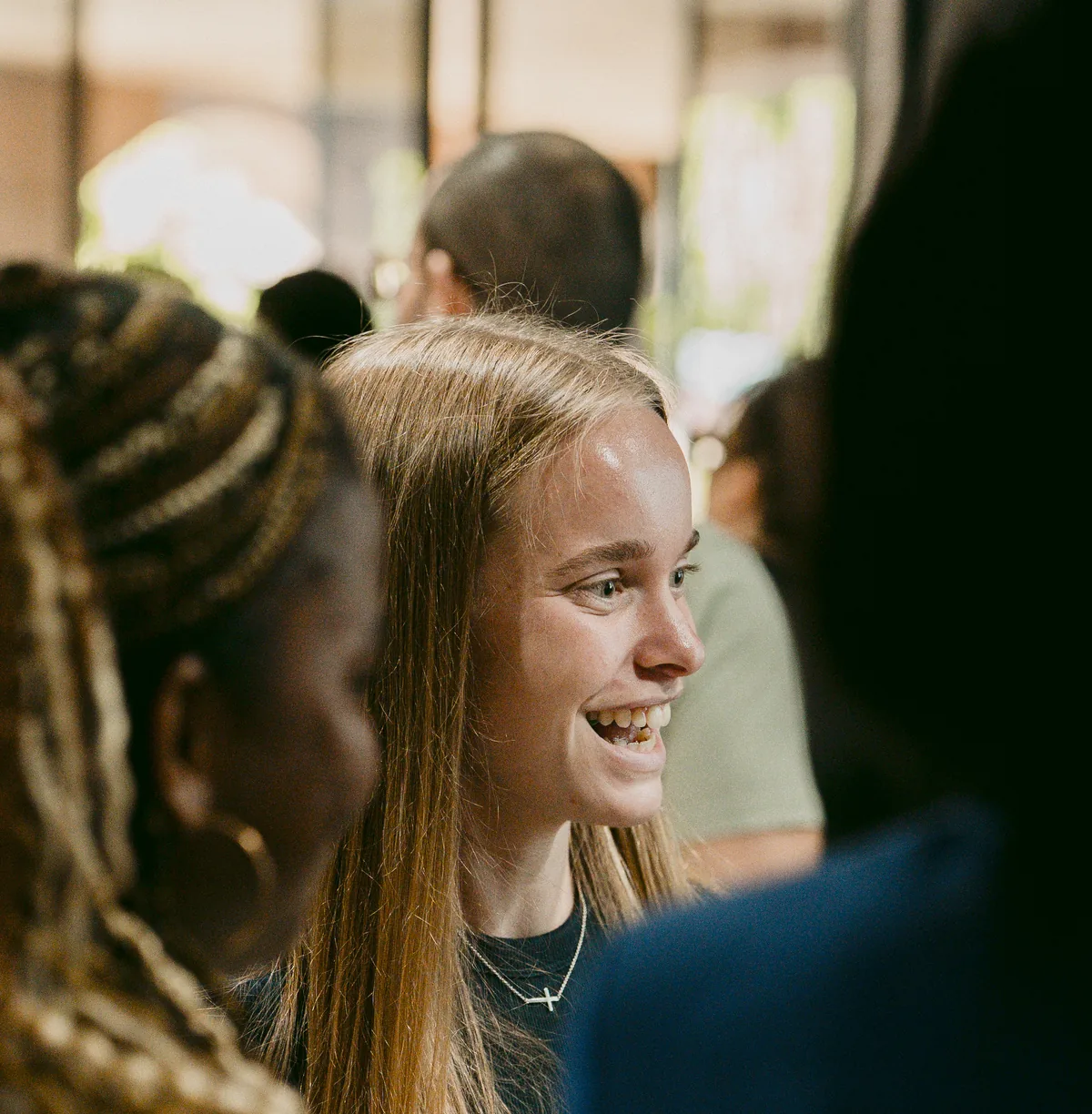 Woman laughing with friends before a service