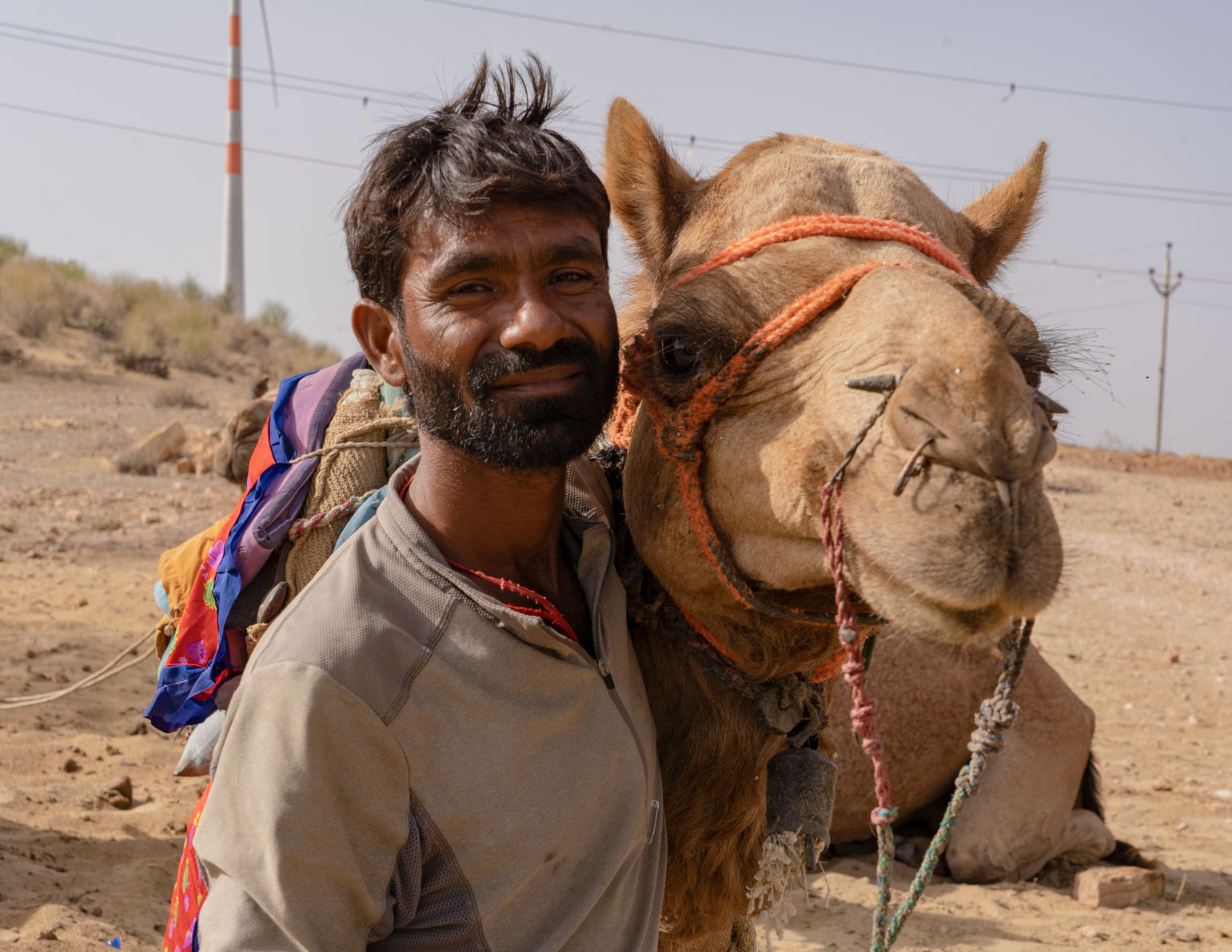 Photo of a guy with a camel in in the desert of Rajasthan, in India