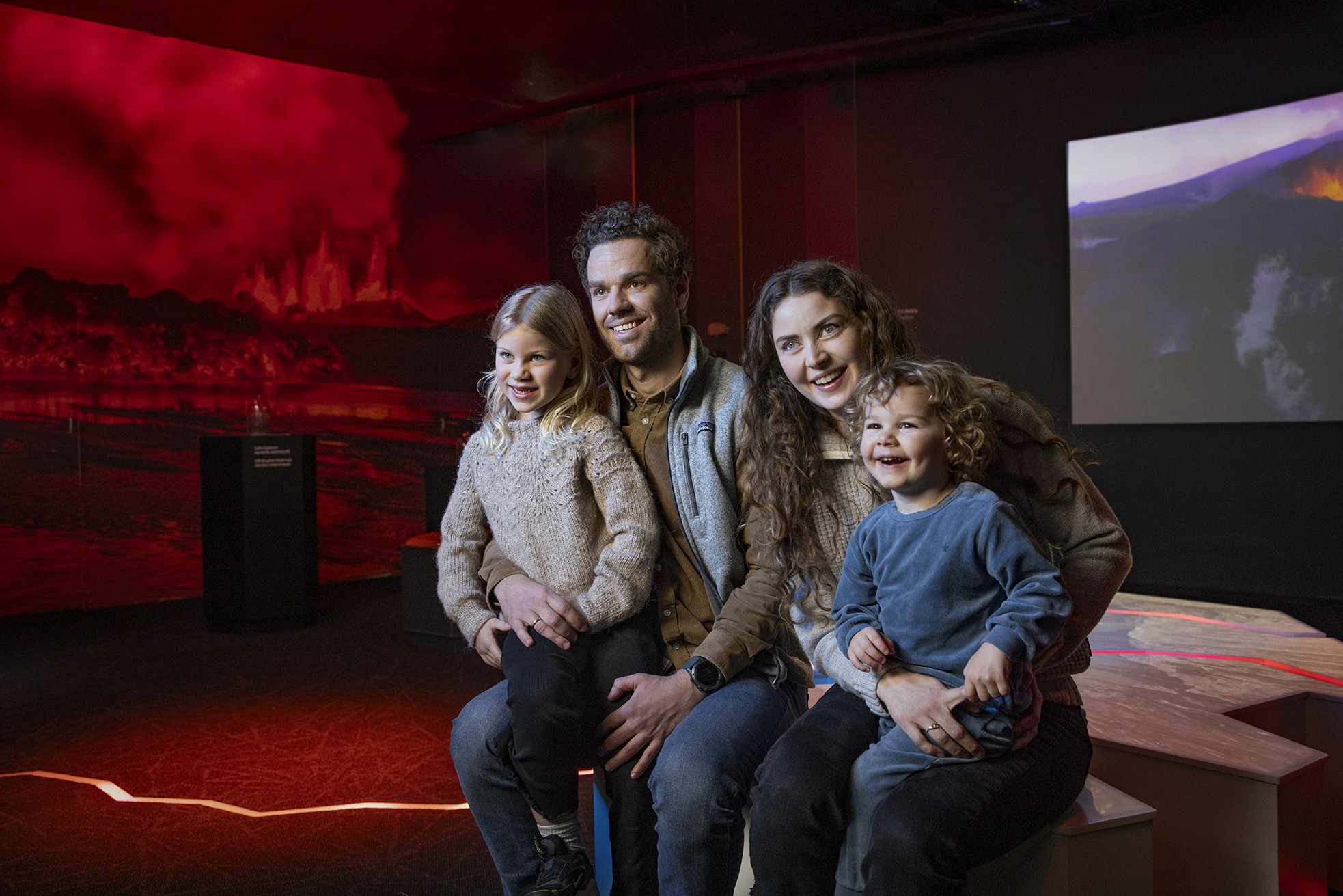 family with young children enjoying the volcano exhibit at perlan reykajvik
