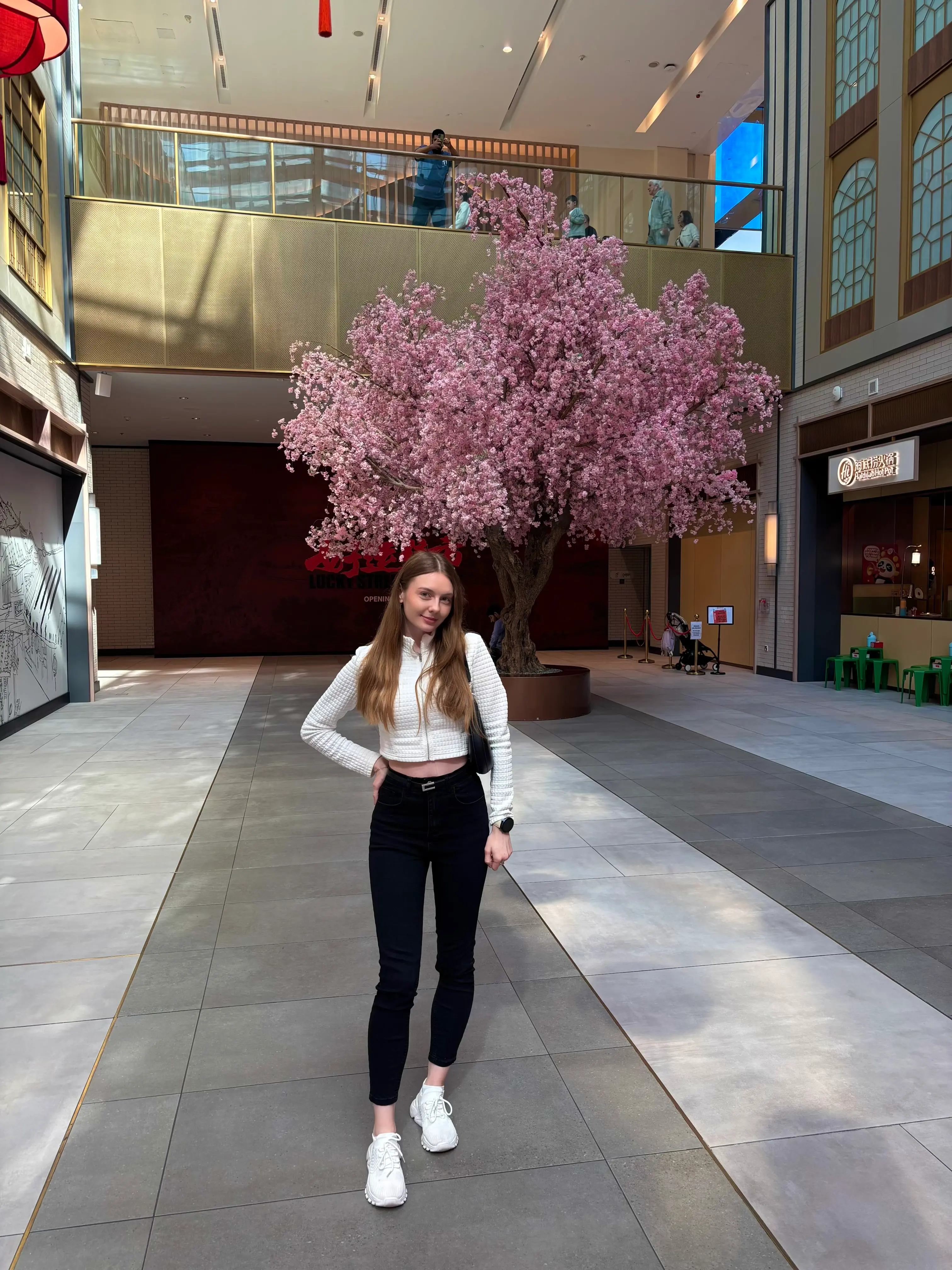 Liana Tudakova, founder of Luna UI, by a cherry blossom tree