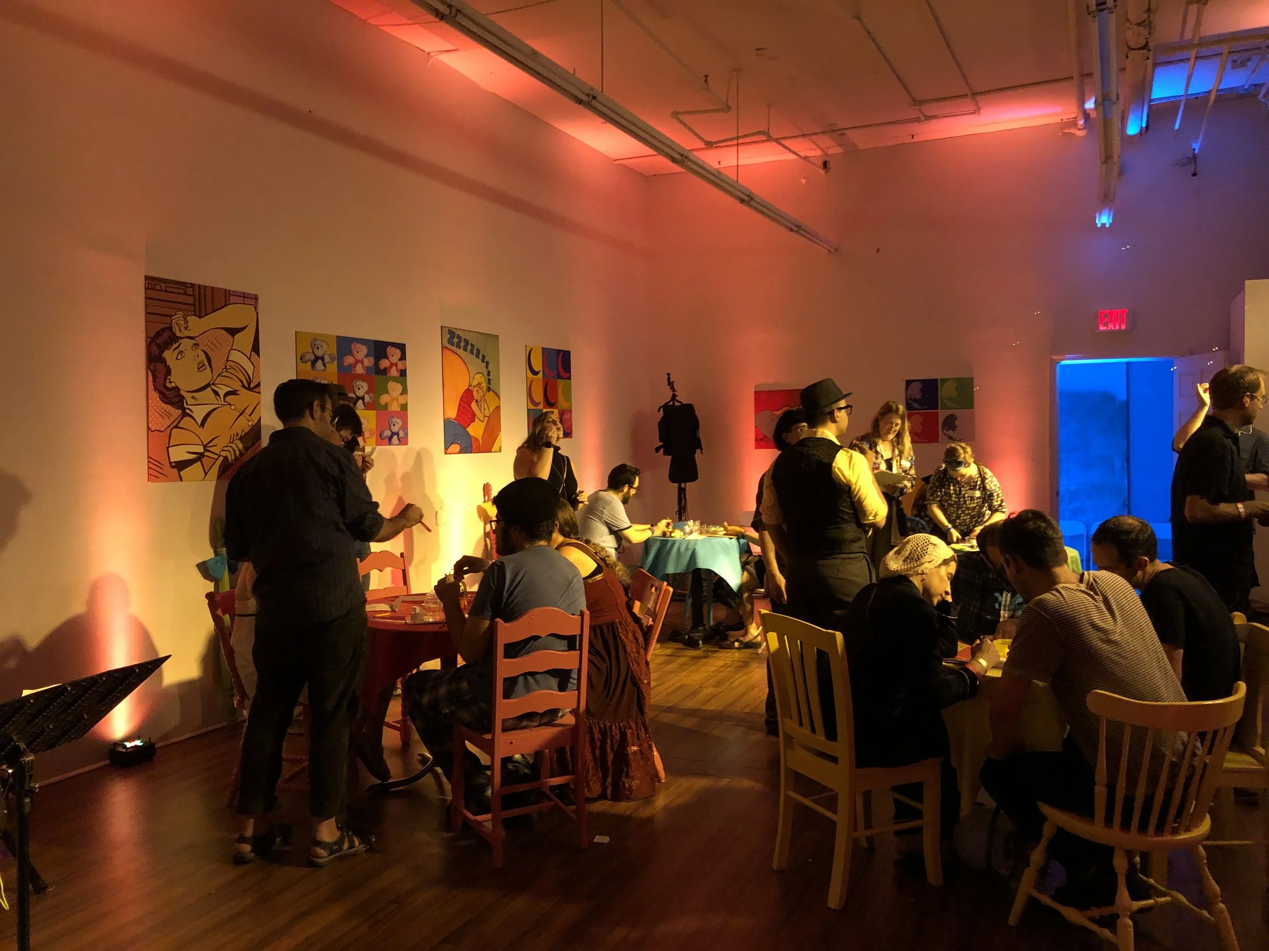 Guests gather in the warmly lit Night Cafe performance space.