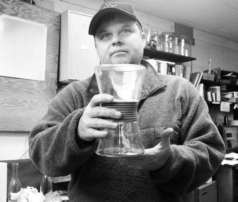 Man holding glass diffuser.