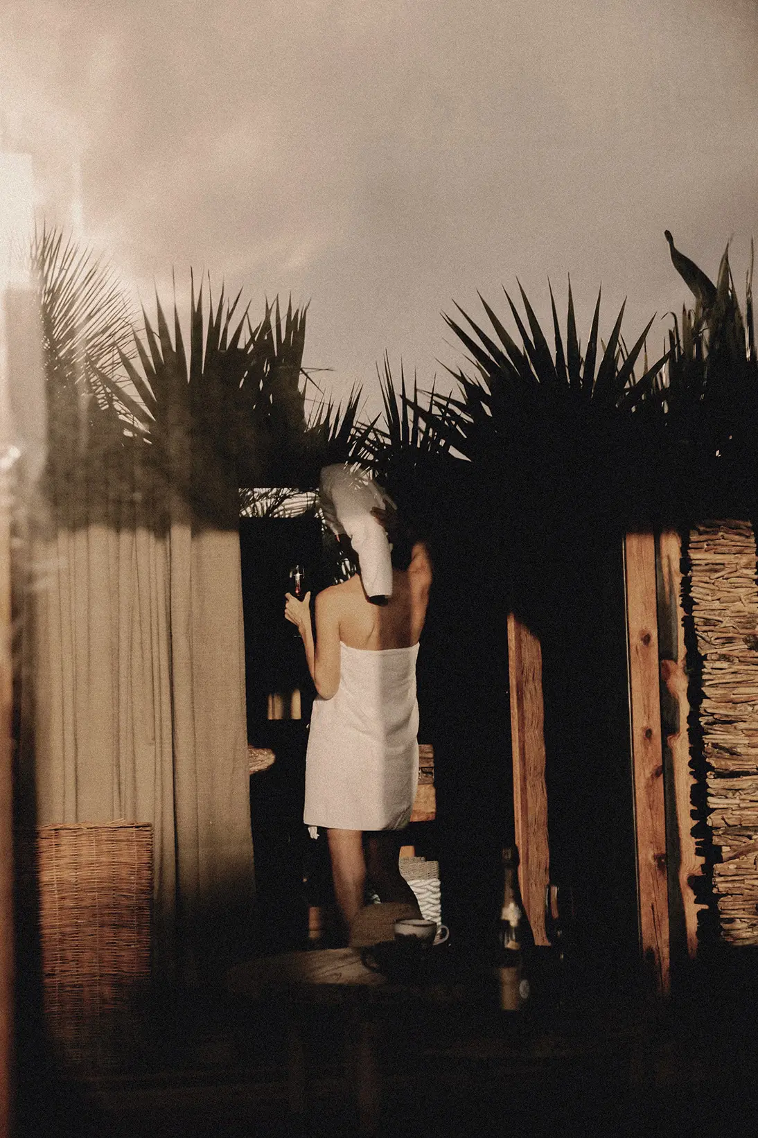 Woman entering the spa area with towels, ready for relaxation at Be Tulum.