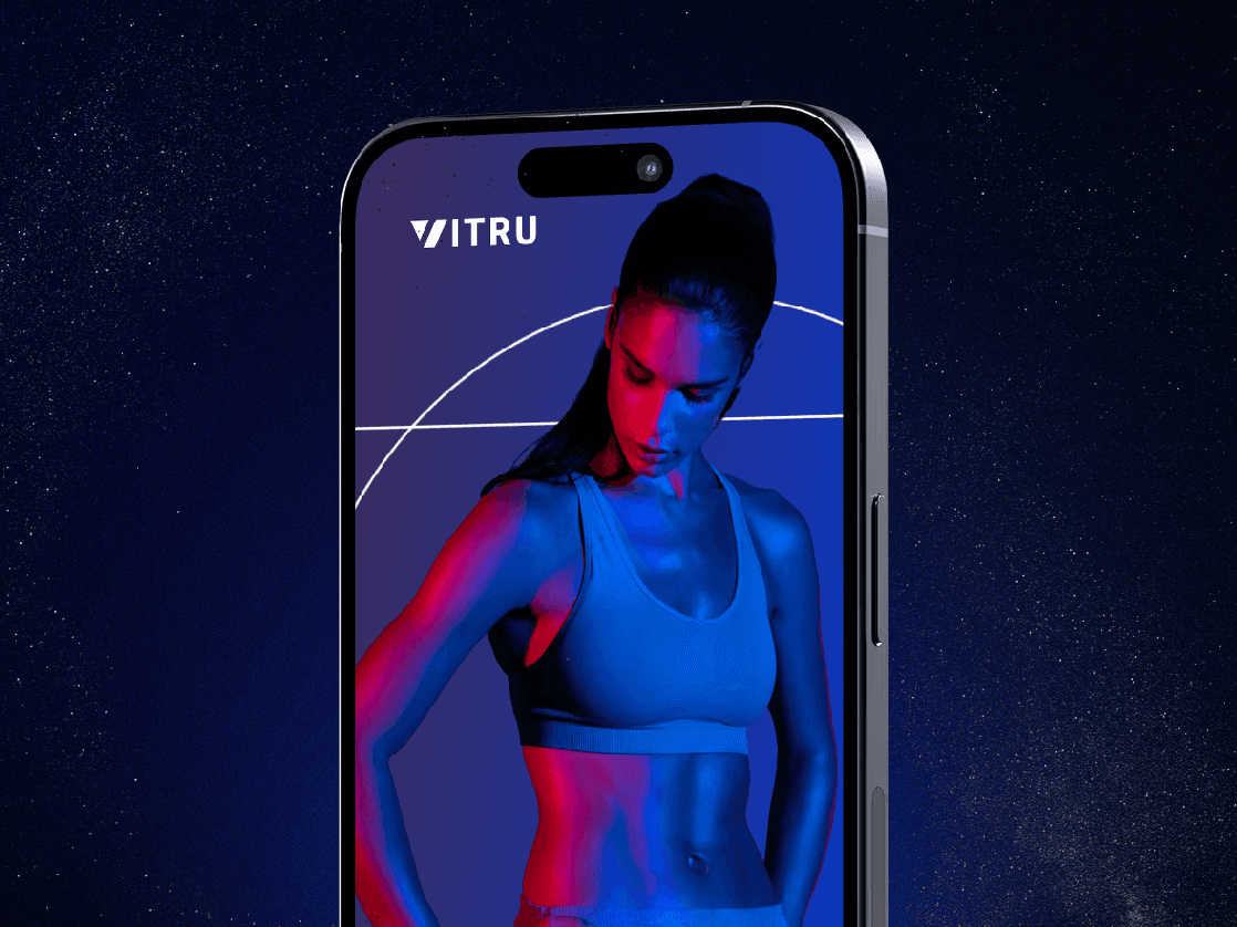 A close-up of a person wearing green-tinted glasses, with a serious expression and smooth skin.