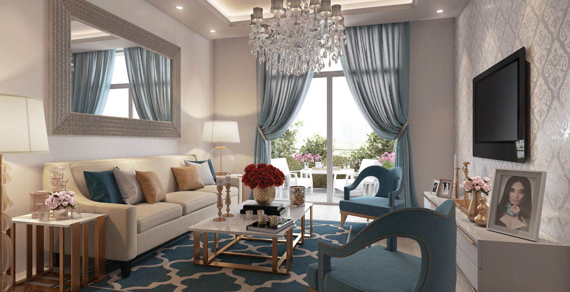 A living room featuring elegant blue and gold decor, designed by Candace Aster, showcasing a stylish and inviting atmosphere.