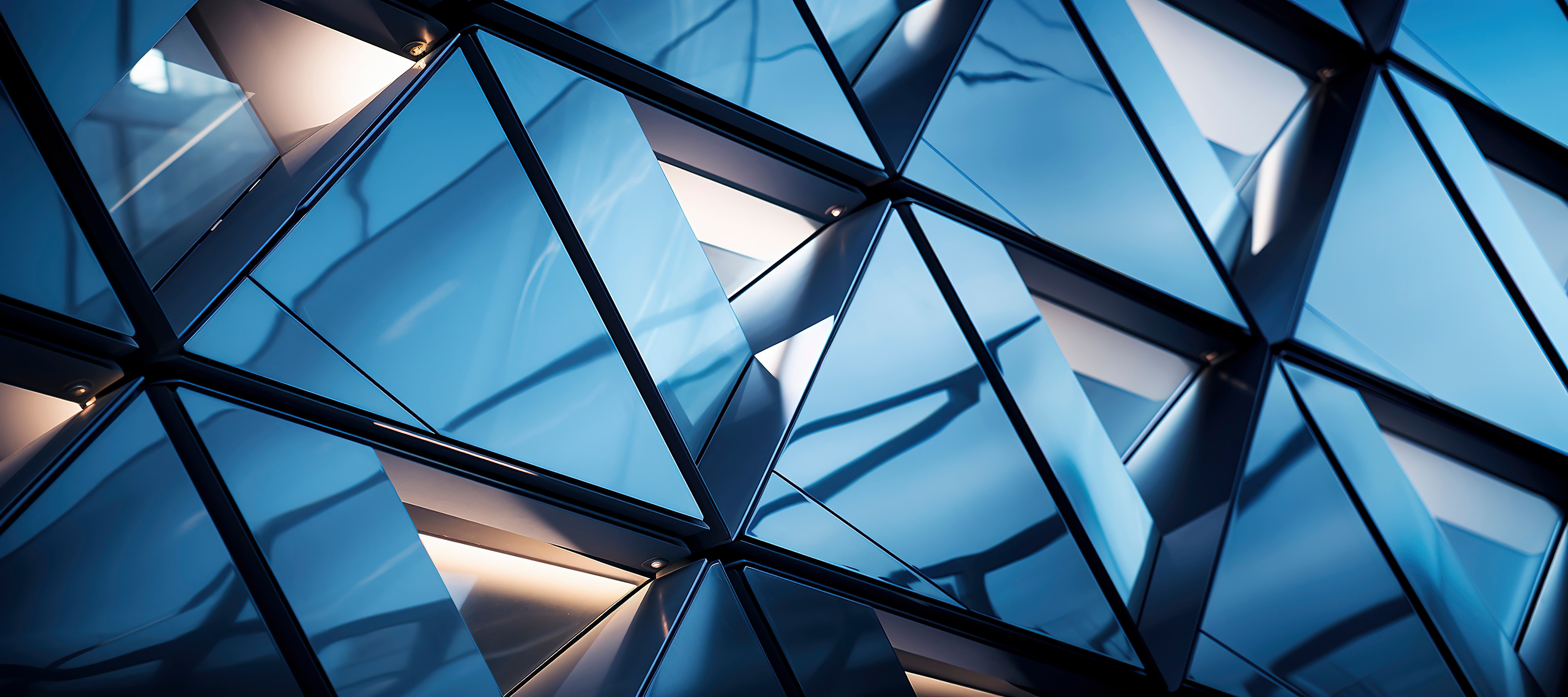 Abstract architectural glass structure with geometric patterns, representing structured, enduring management systems and organisational design.