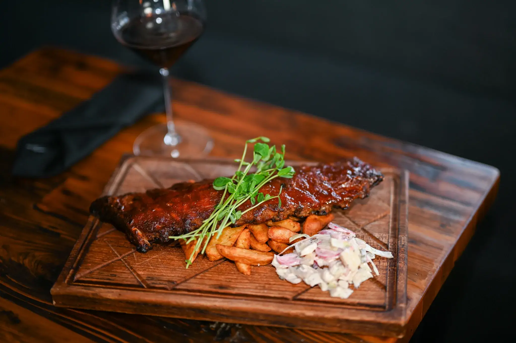 Ribs and wedges on a wood platter