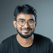 Profile portrait of a man in a grey shirt