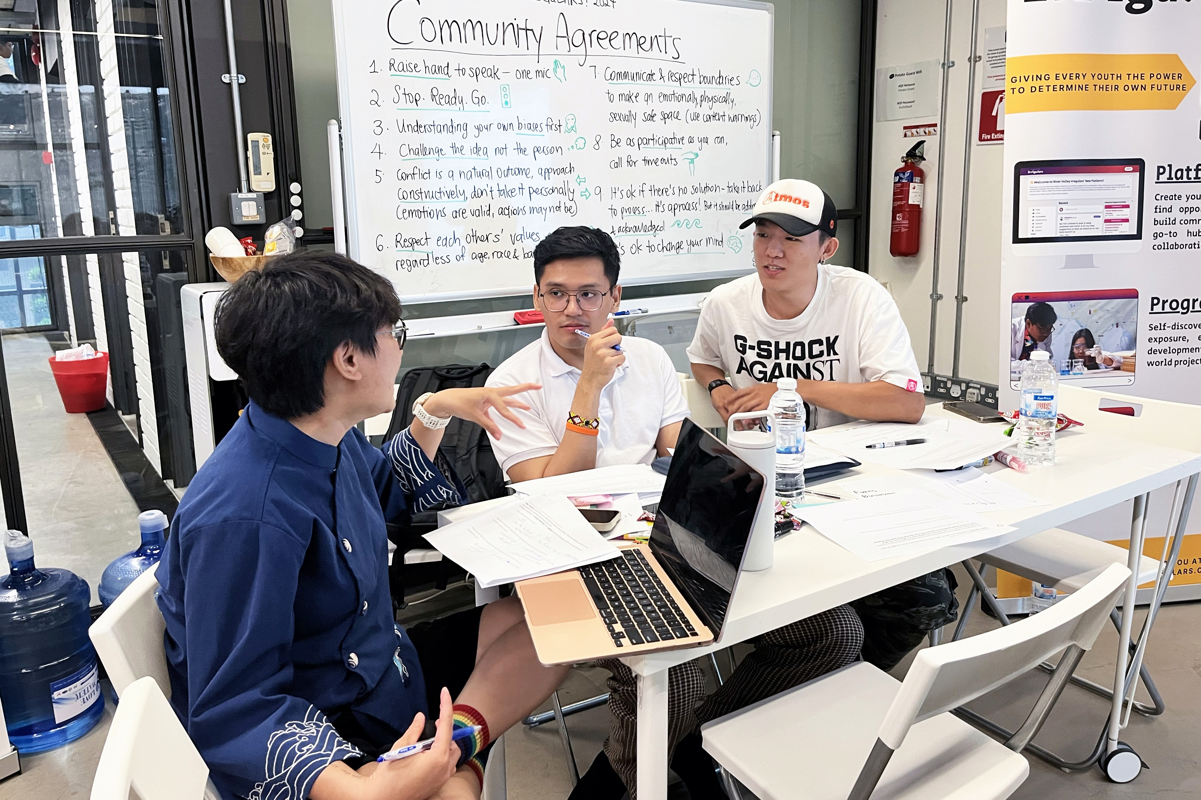 Three workshop participants practice interviewing each other during the Empathy session